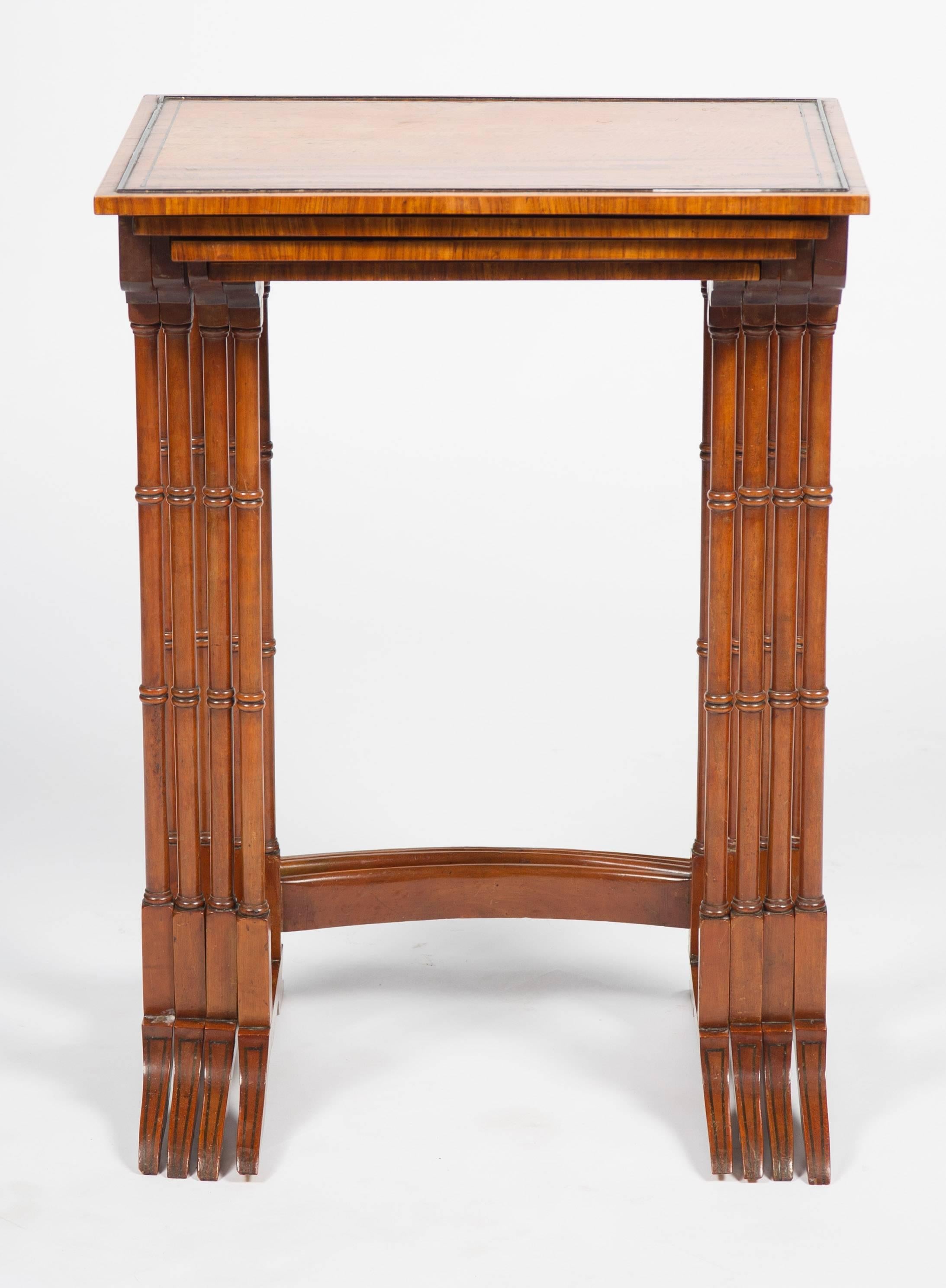 Avery good quality nest of four 19th century satinwood tables, each with ebony string inlay. The legs with ring turnings and united by a curved stretcher below, terminating on out swept feet.