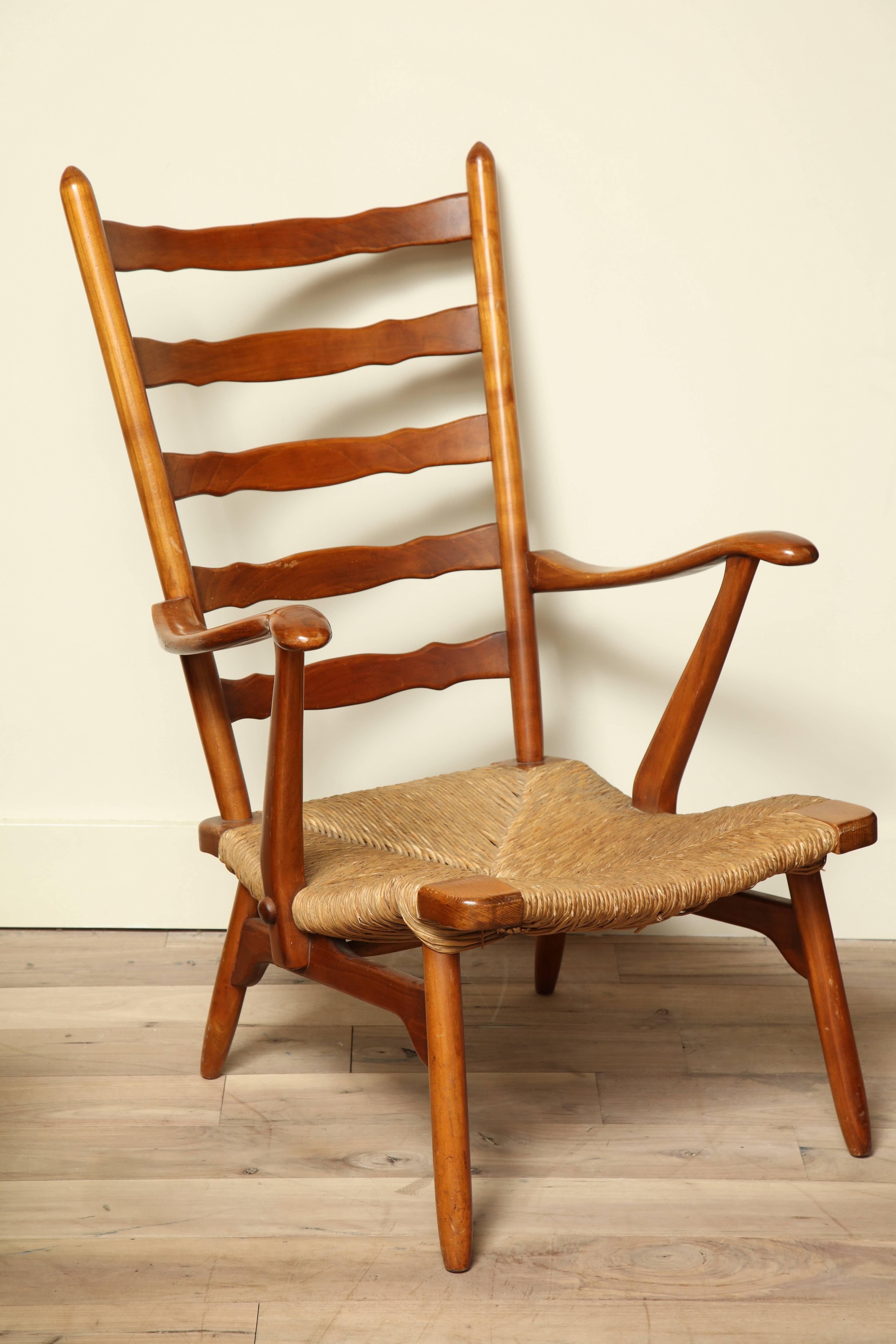 French Mid-Century ladder back lounge chair with rush seat.