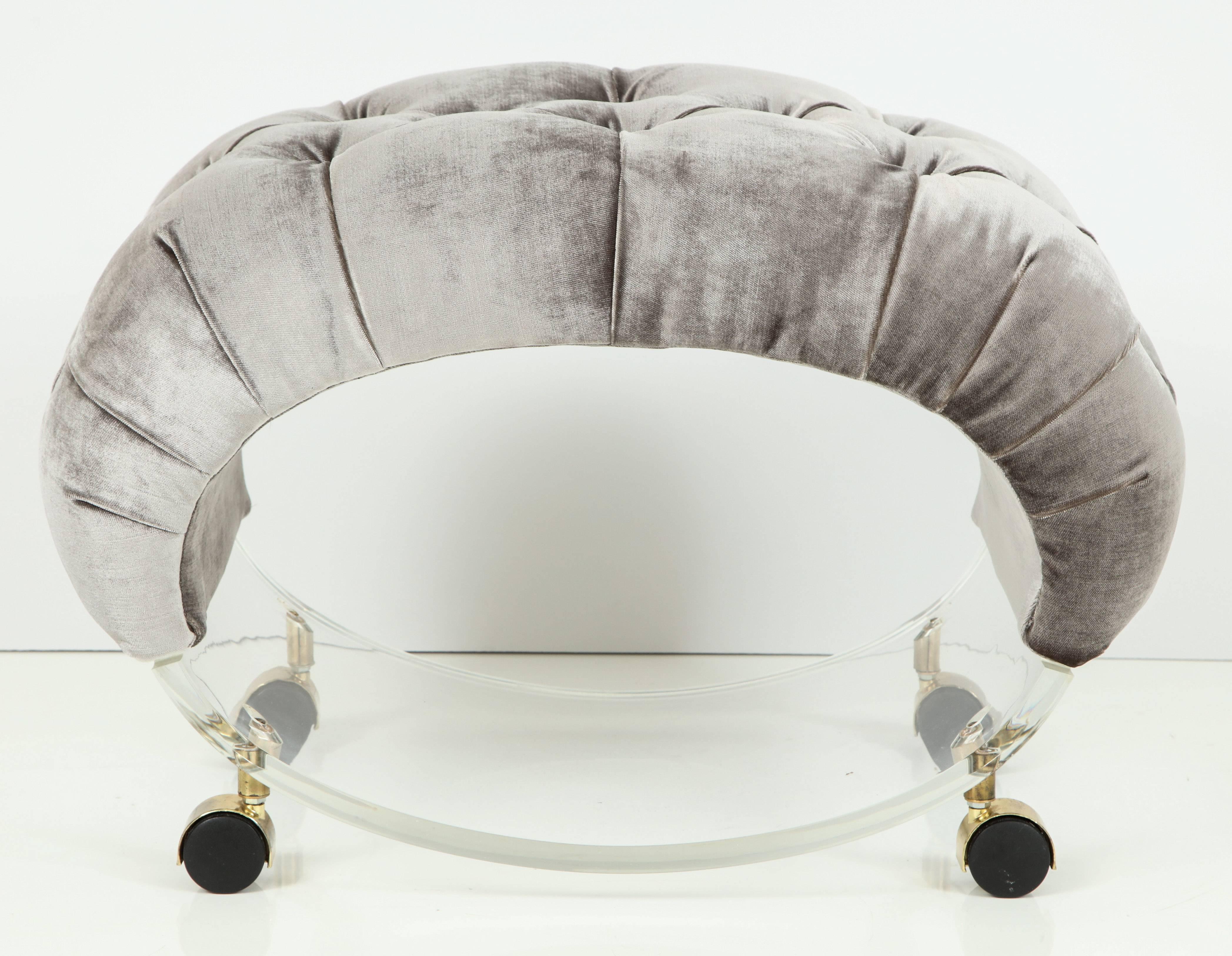 This unique sculptural Lucite stool is a jewel. Original brass casters and Lucite is in excellent condition with a few minor scratches from age that cannot even be photographed they are so light and minor. Newly upholstered and tufted in a luscious