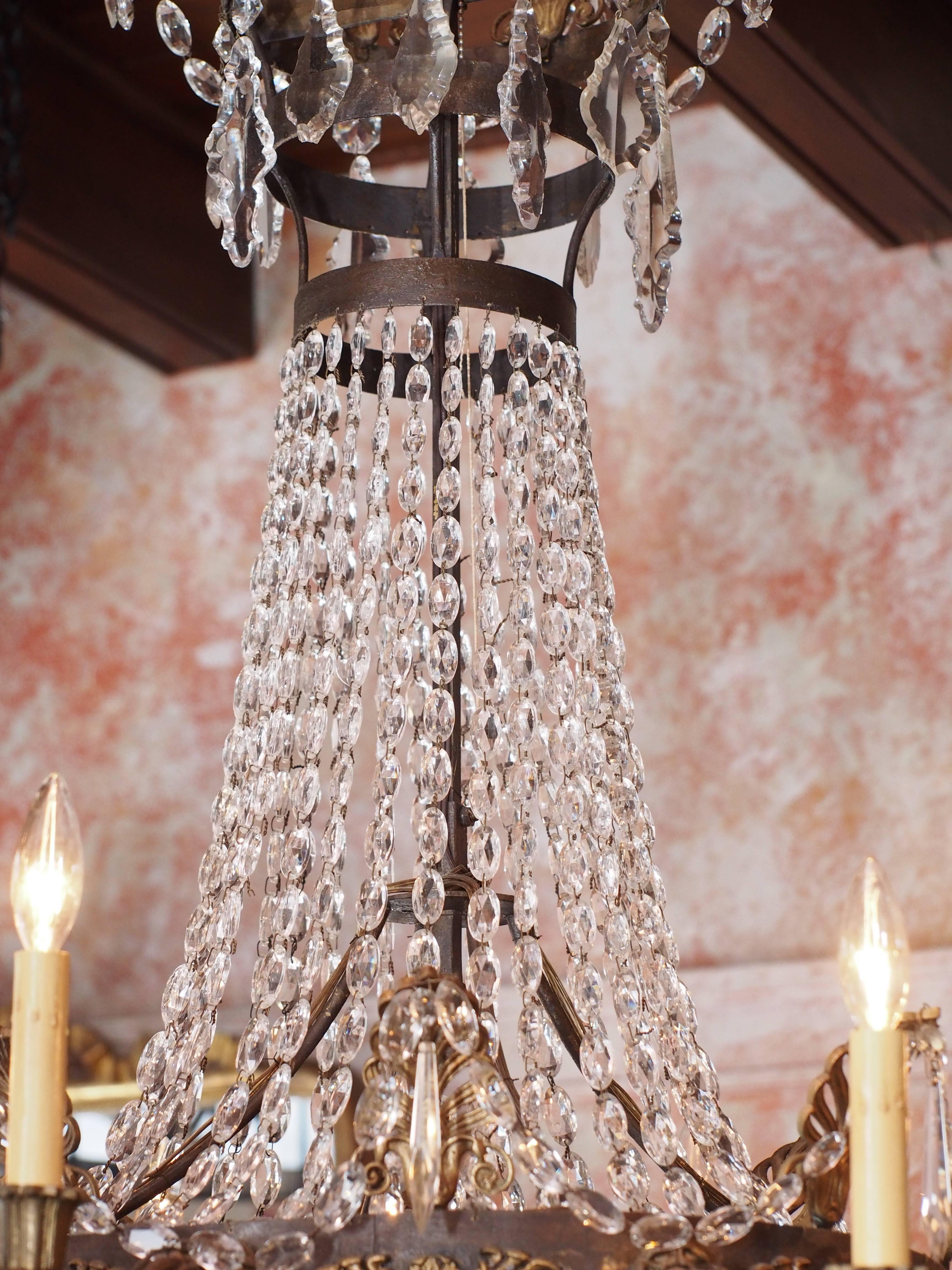 Antique French Empire crystal and bronze eight-light chandelier.