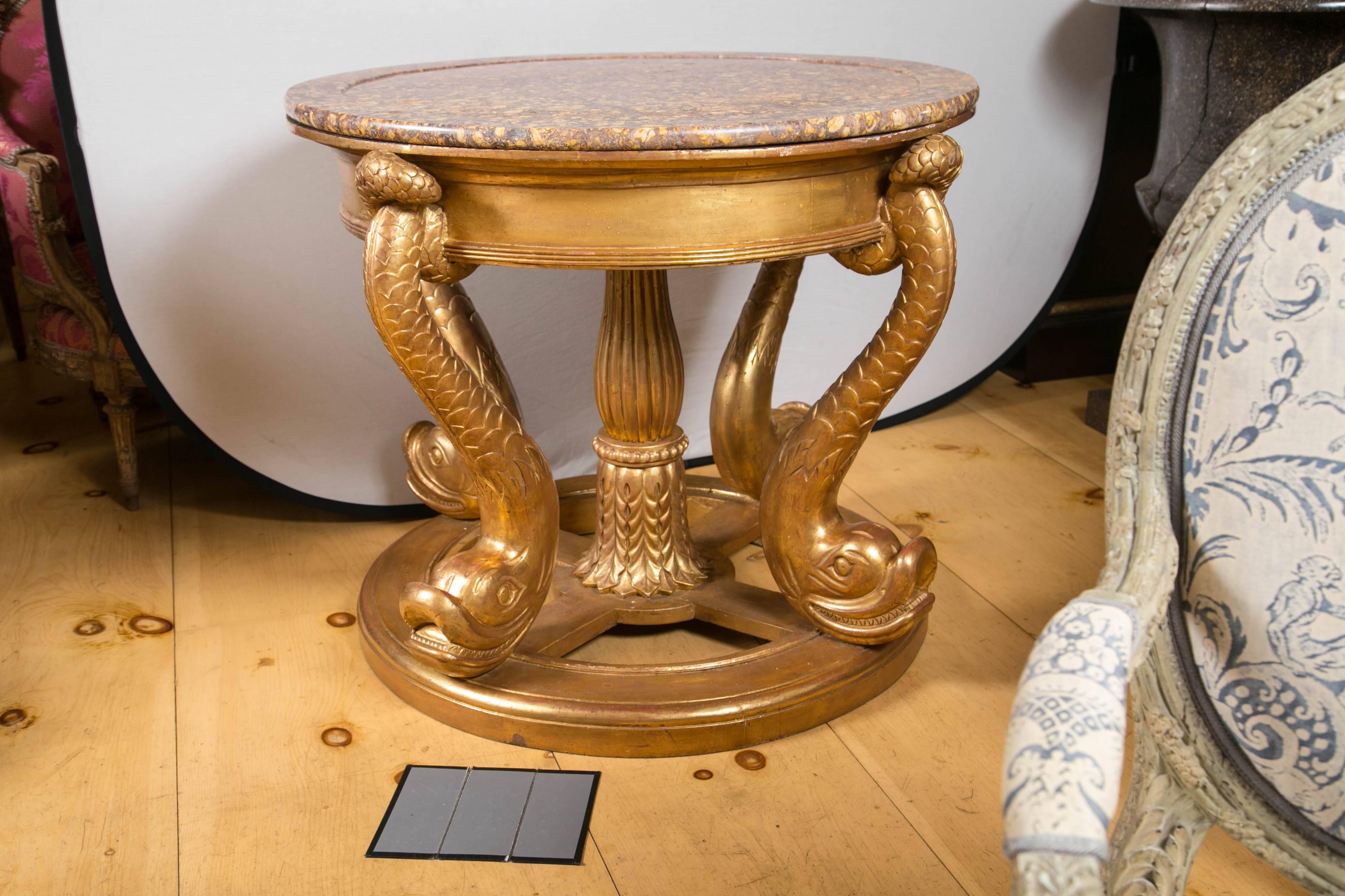 This dramatic table has a raised edge marble top. Four stylized dolphin legs with a center pedestal column are attached to the circular base.

Shipping cost is an estimate.