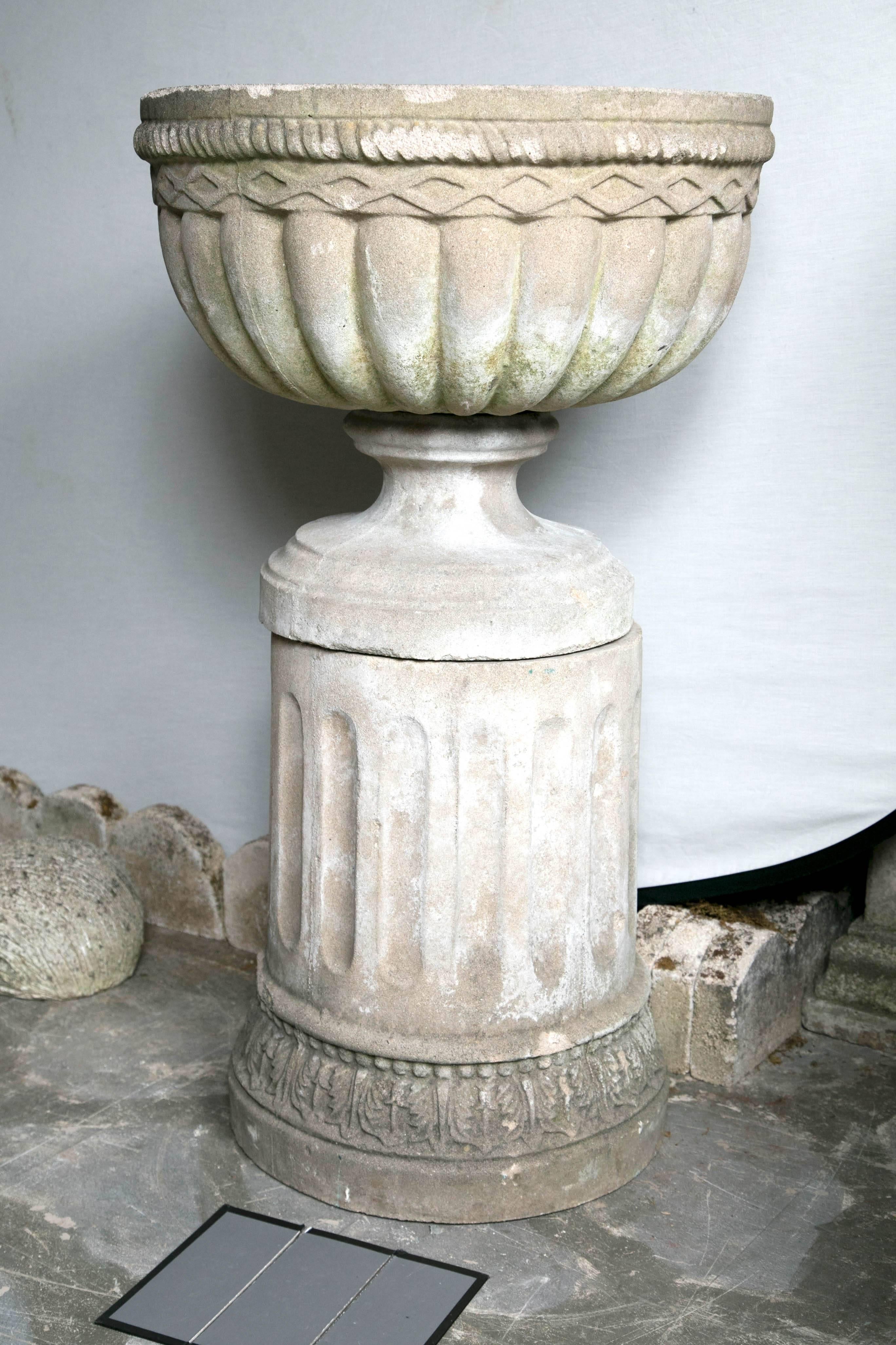 Fabulous pair of composition stone English garden urns with matching bases.