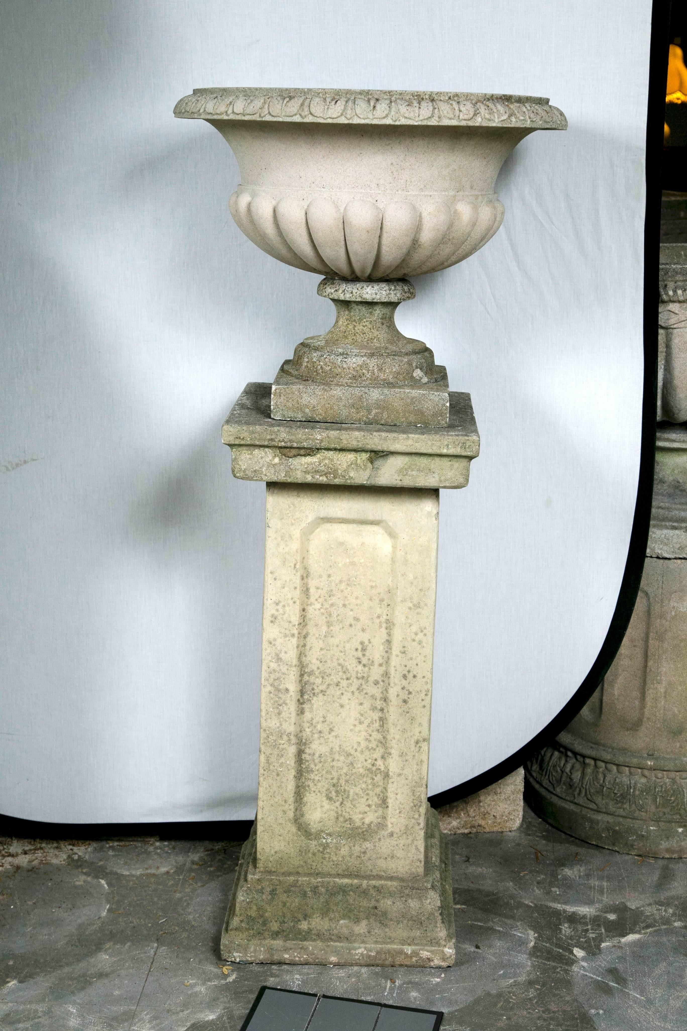 Stunning pair of English garden urns on stands.