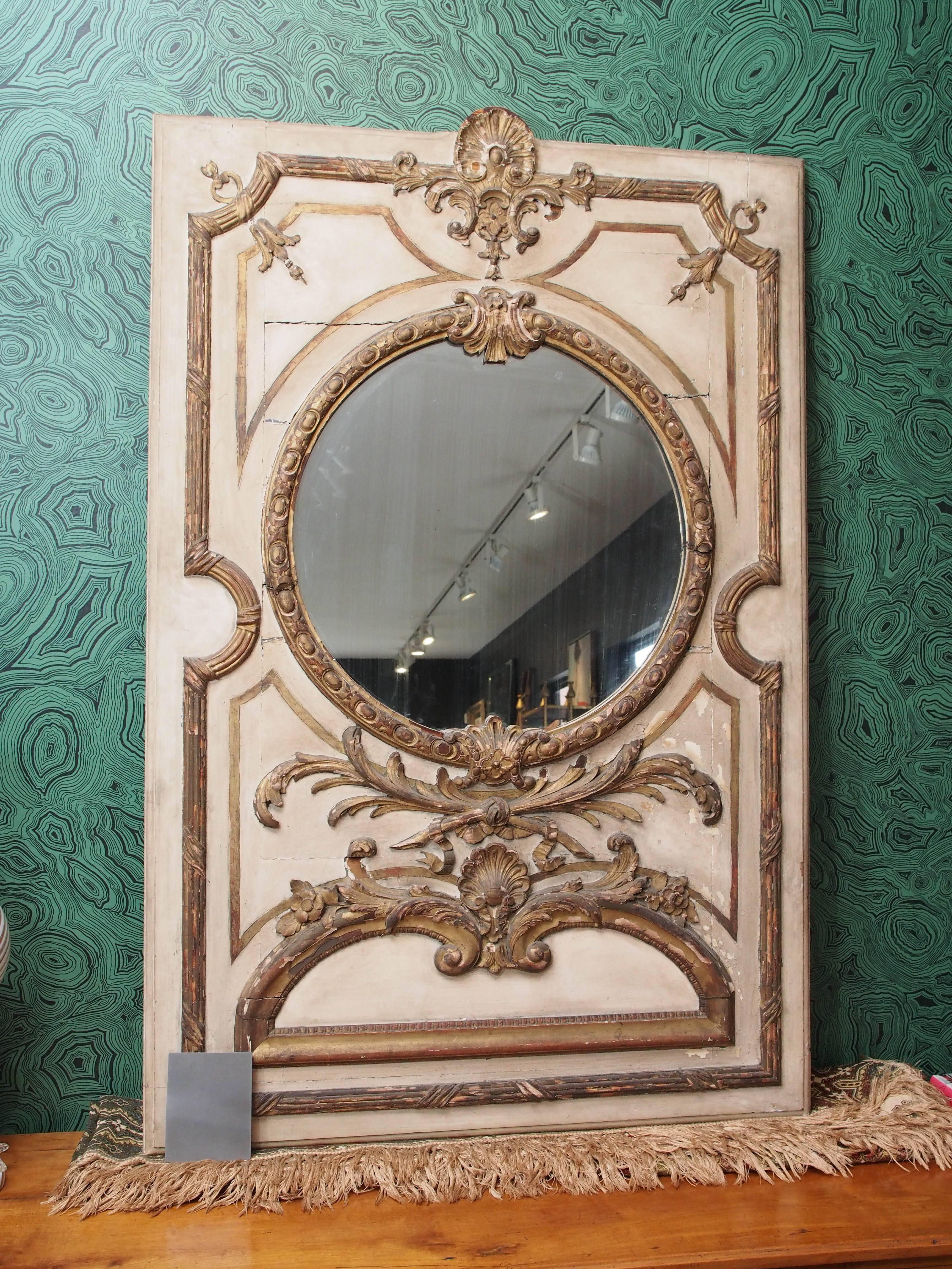 Beautiful trumeau mirror with carved accents. Cream and gold.