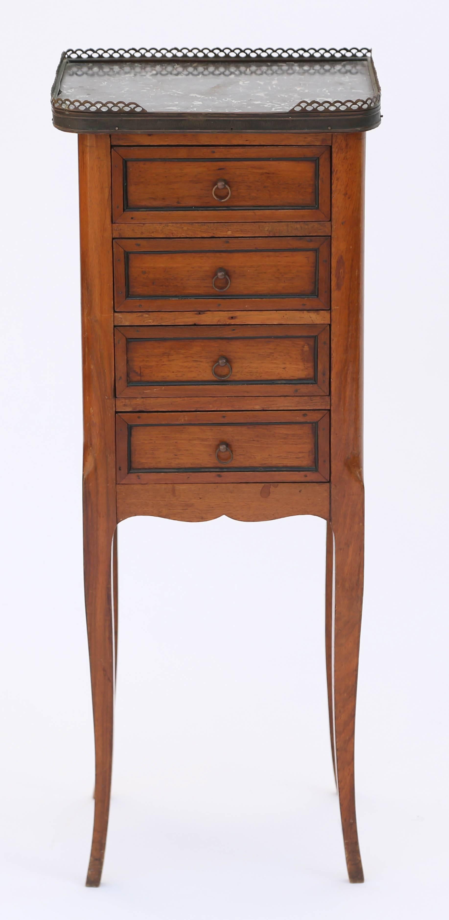 Adorable chest, of walnut, having a rectangular top of marble, with rounded front corners, surrounded by a pierced 3/4 gallery, on case with four stacked drawers, each with a fielded panel fronts, and small ring pulls, over serpentine apron, raised