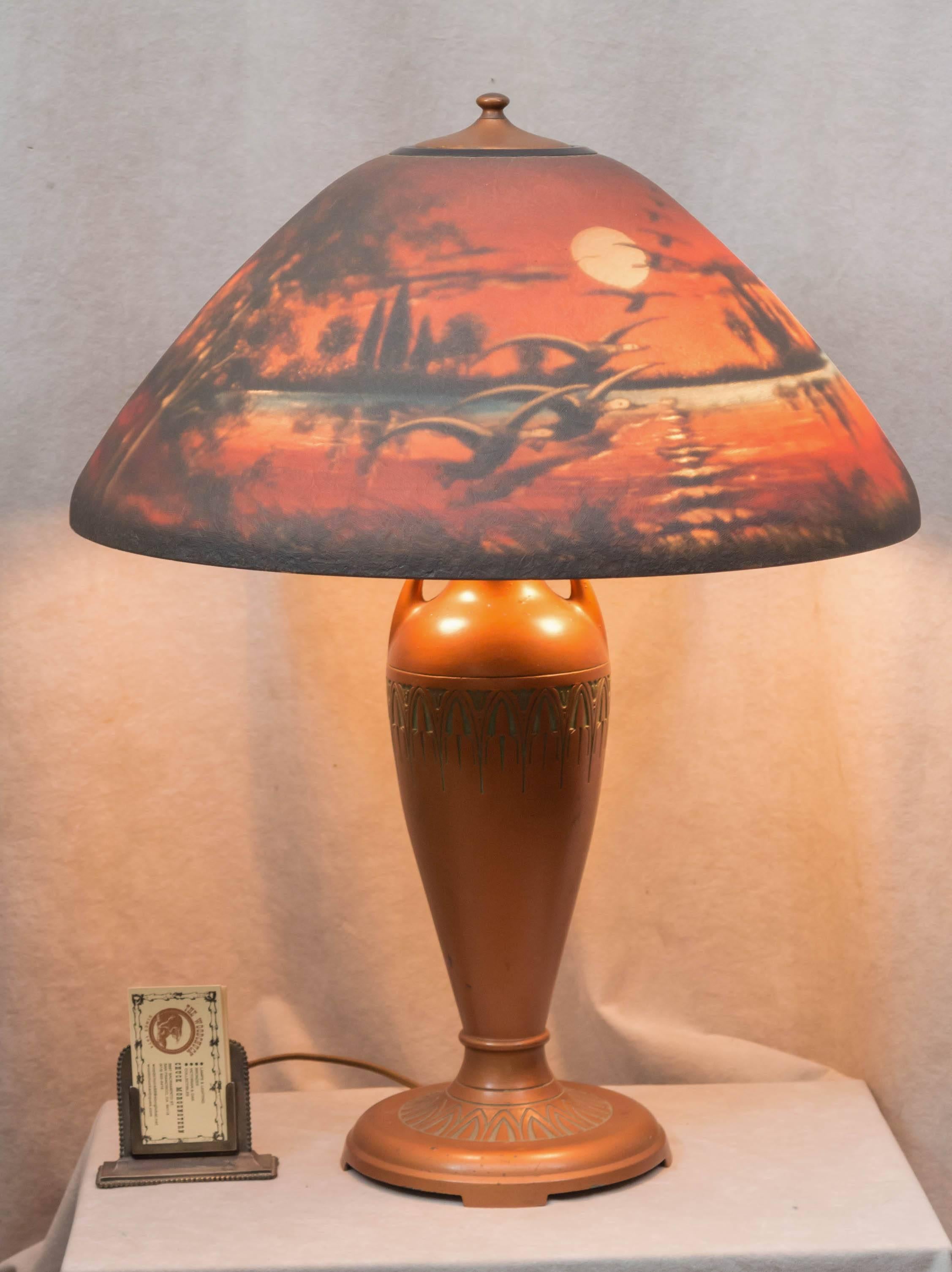 We sell lots of antique table lamps in our shop. We mainly sell Tiffany and other leaded glass lamps. On occasion we will buy this style of lamp known as "reverse painted". These lamps are, in fact, painted on the inside. This is one of
