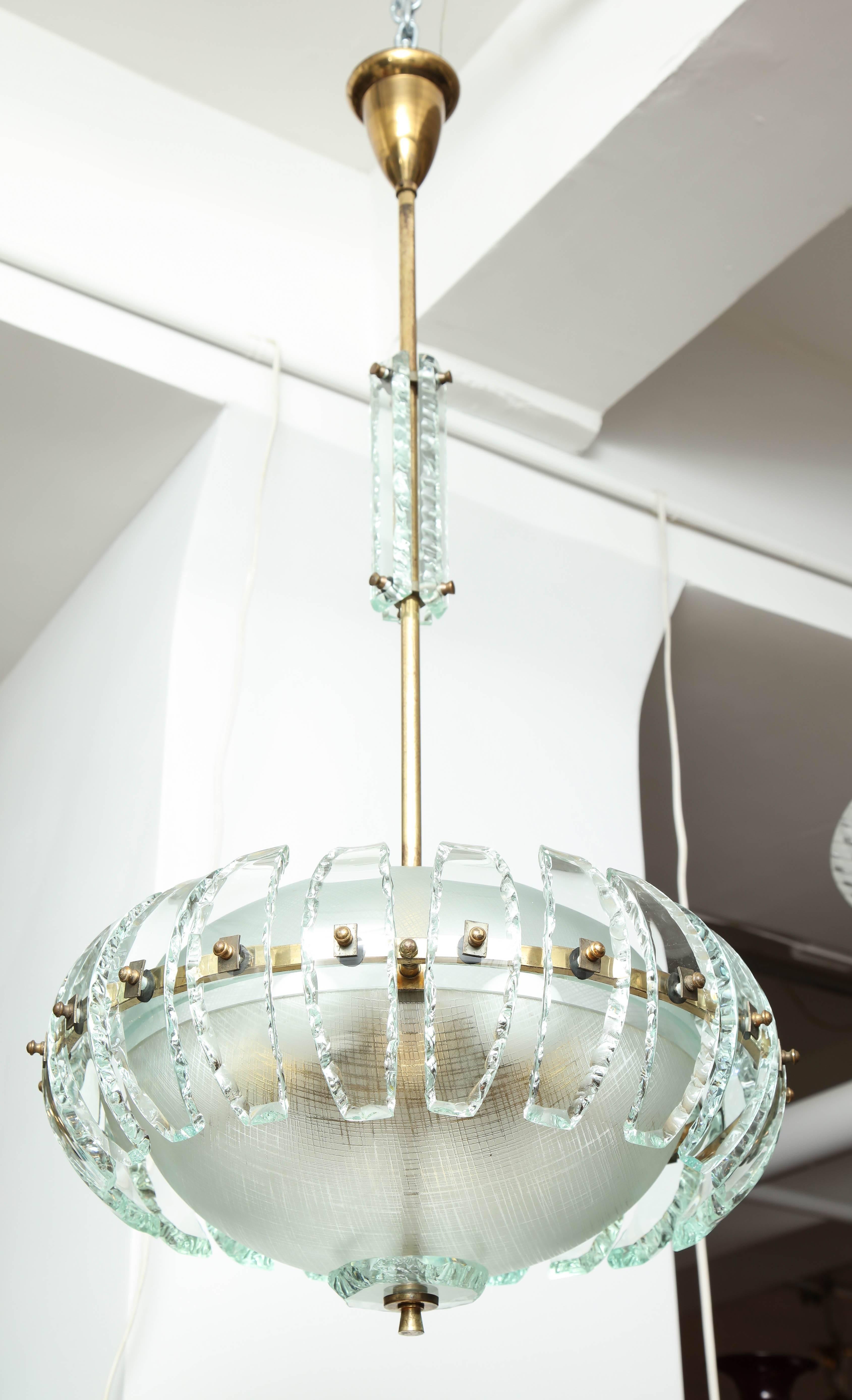 Crystal Arte pendant / chandelier made in Italy, 1955, exciting design, fixture having two half round acid etched lines criss crossing each other shades with 21 pieces of curved chipped glass hugging the sides of the fixture, chipped glass panels on