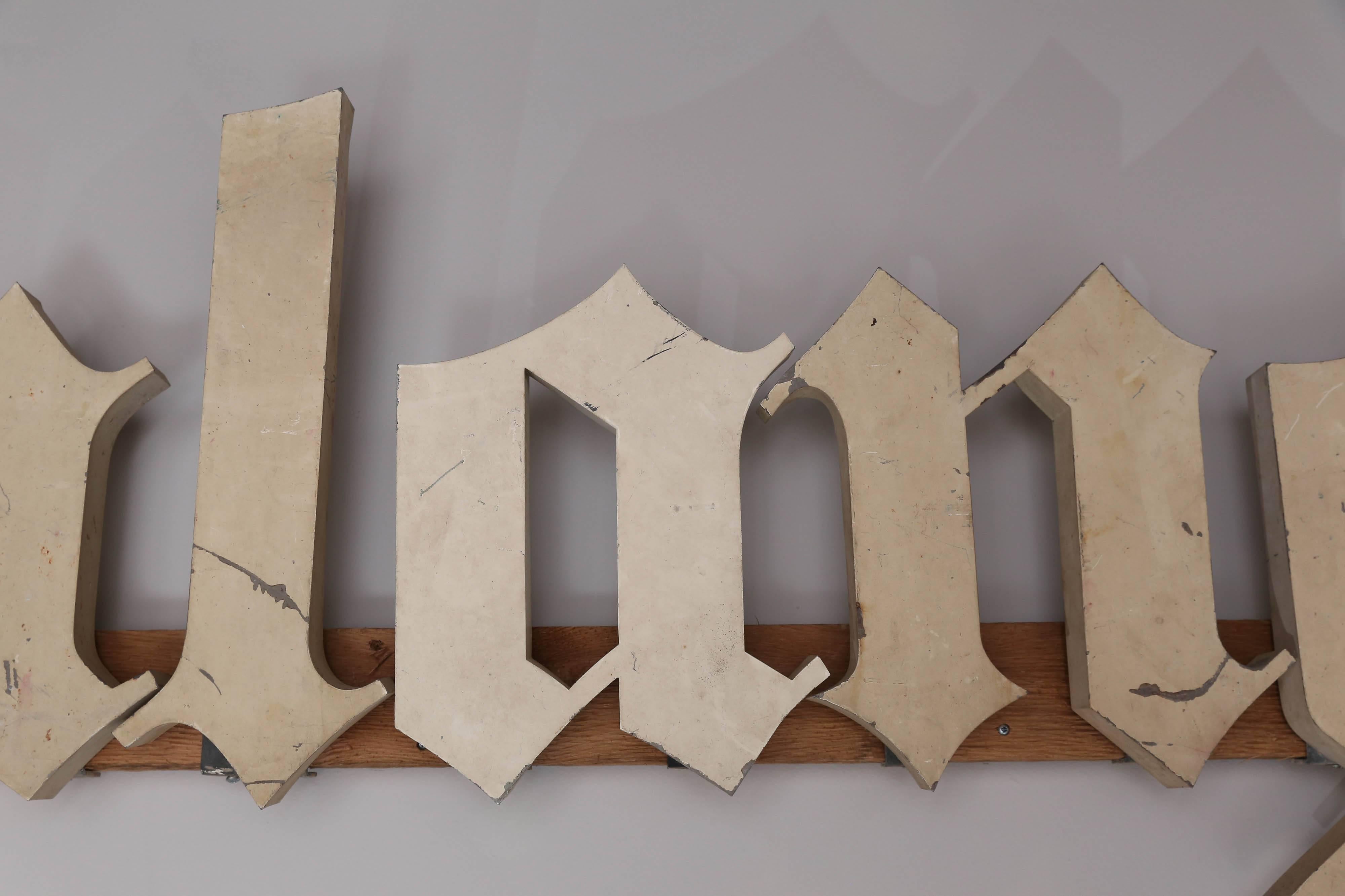 Antique Boulangerie bakery shop signage from France in a beautiful cream metal. Each letter measures approximately 1.5 inches deep and are mounted onto a pine 2x4 to keep straight, but this can be removed so that each letter can be individually