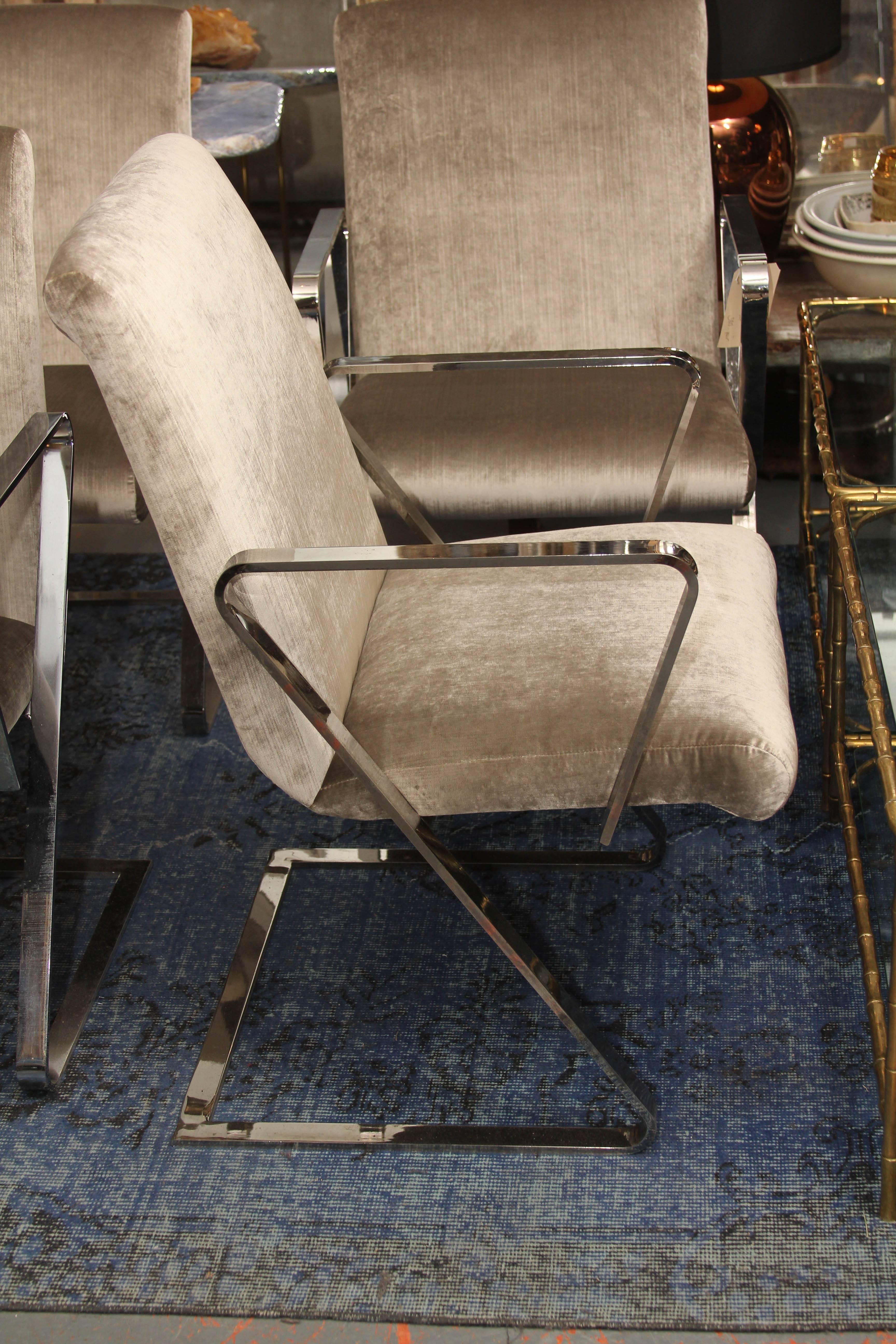 Pair of springer style chairs with heavy chrome frame upholstered in beautiful silk velvet. Each pair priced at 3800. Perfect side chairs or dining chairs. These are super comfortable and the spring factor make these chairs the ones you will want to
