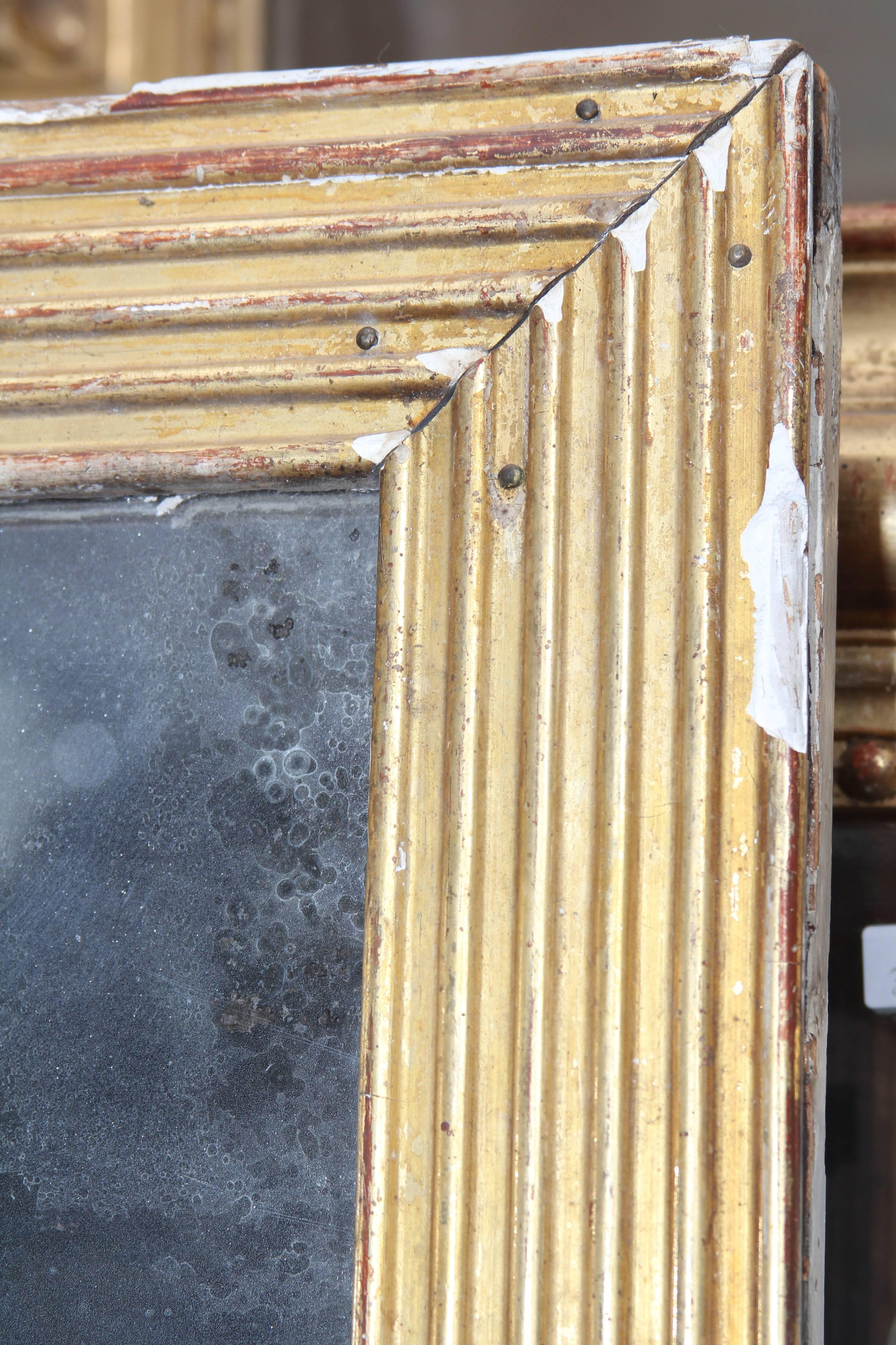 Simple gilded wood frame, three-panel mirror with lovely distressing. Beautiful sitting on the floor or hung vertically or horizontally.