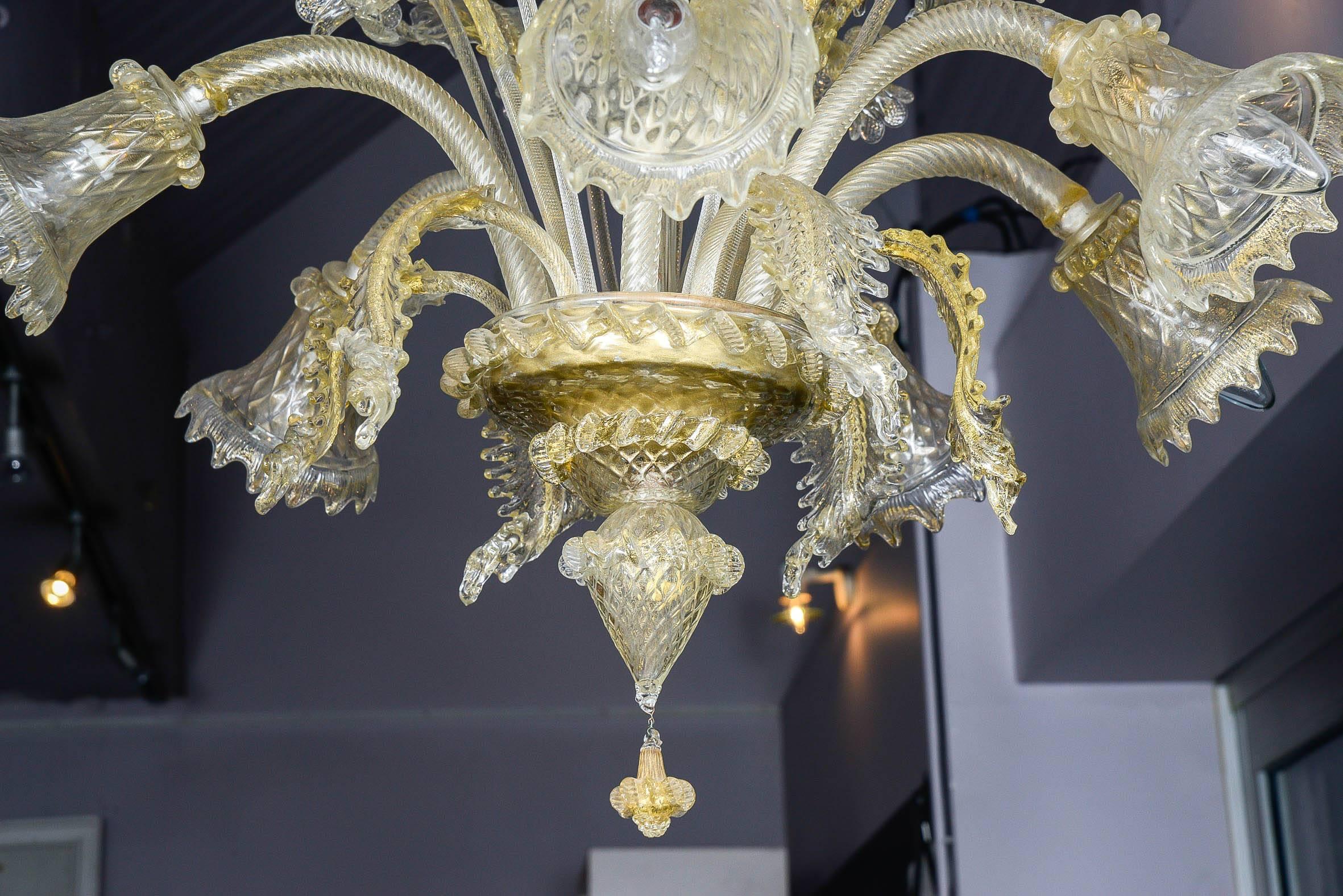 Chandelier in gold and transparent Murano glass with six lights.
