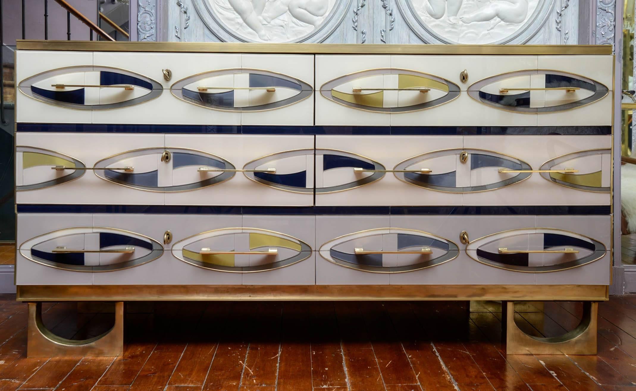 Commode in colored mirror navy blue, ivory, grey and black, six drawers, fillet, handles and legs in brass.