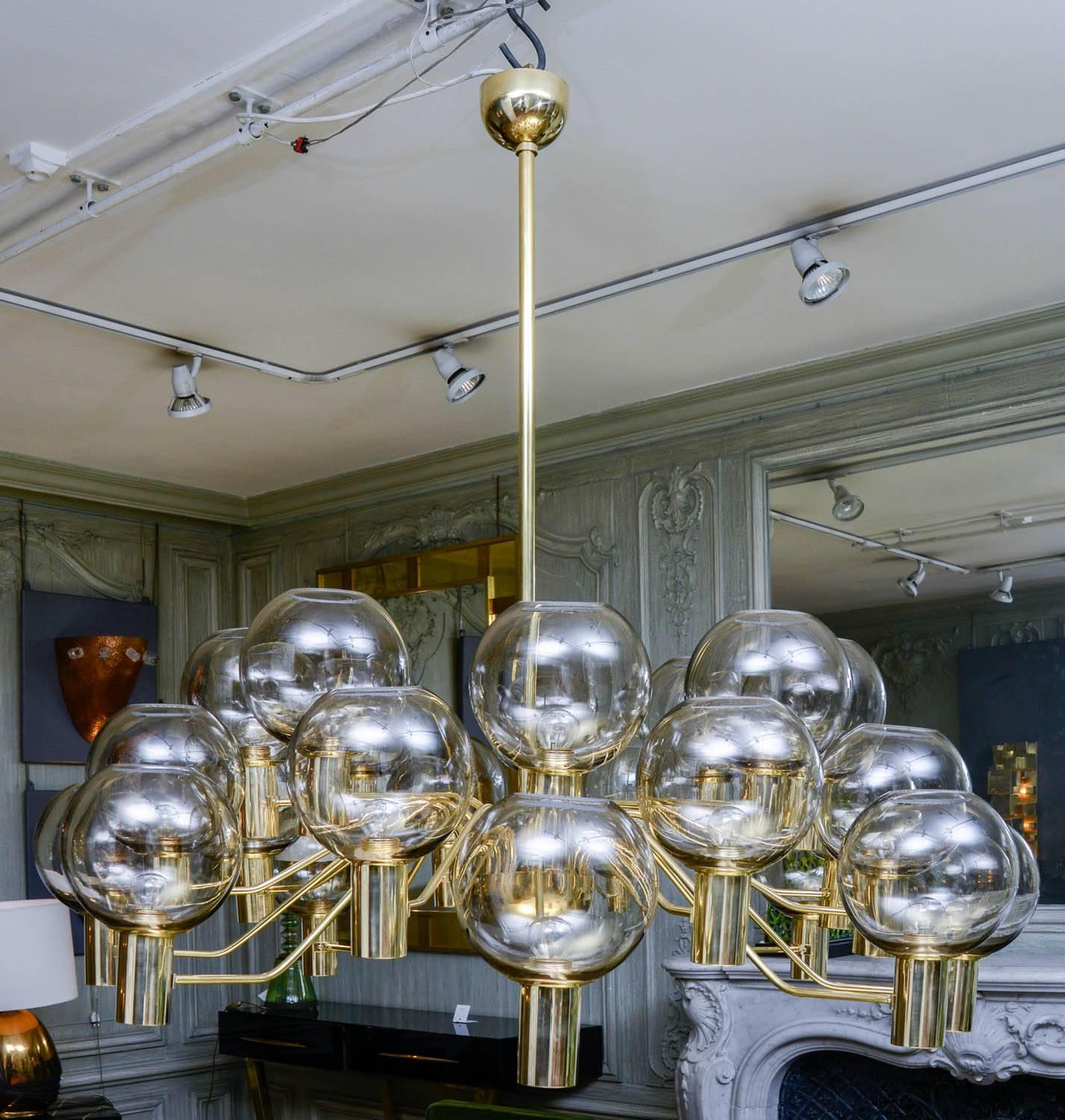 Chandelier with a brass structure and 24 smoked glass globes