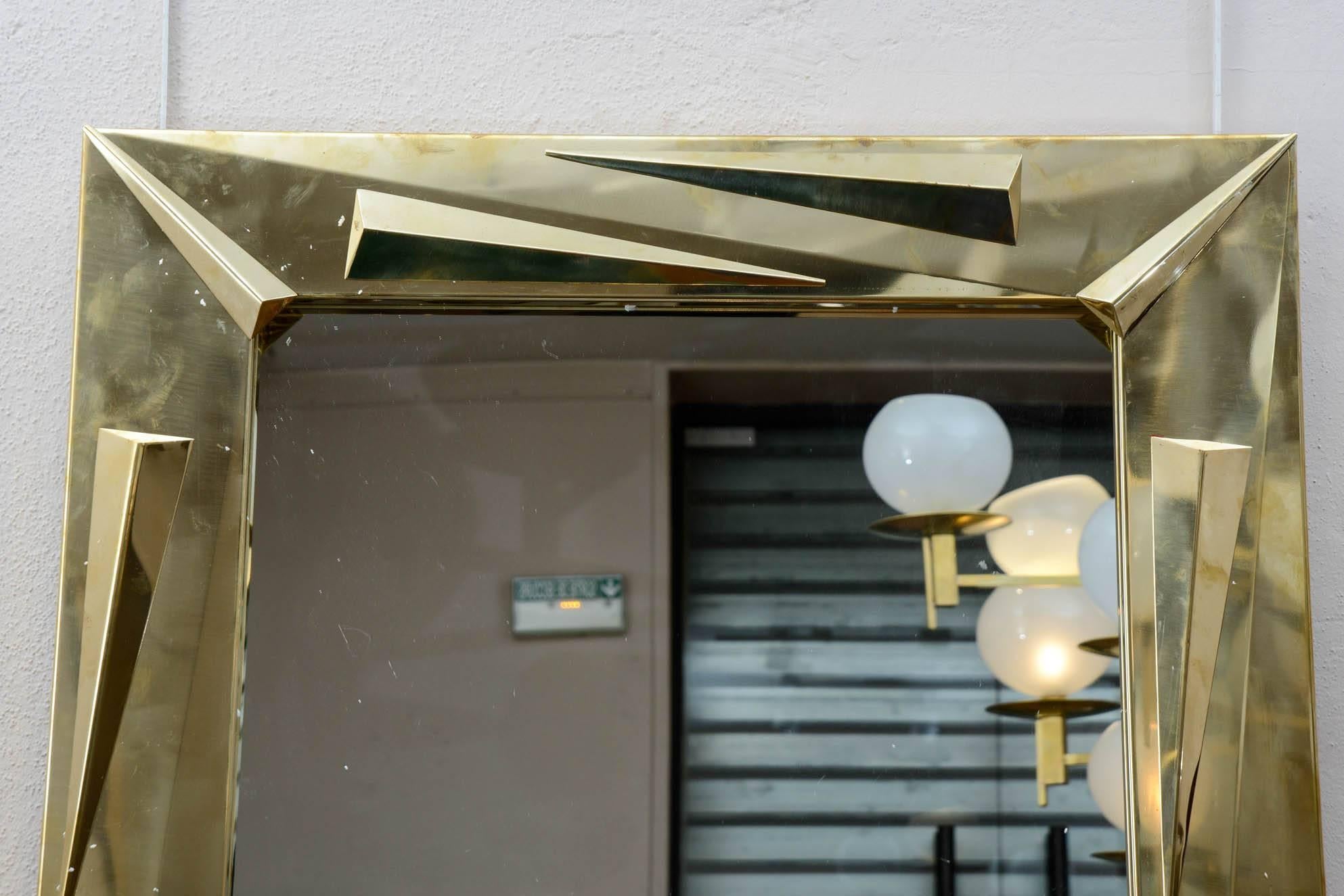Pair of brass mirrors with geometrical decoration.