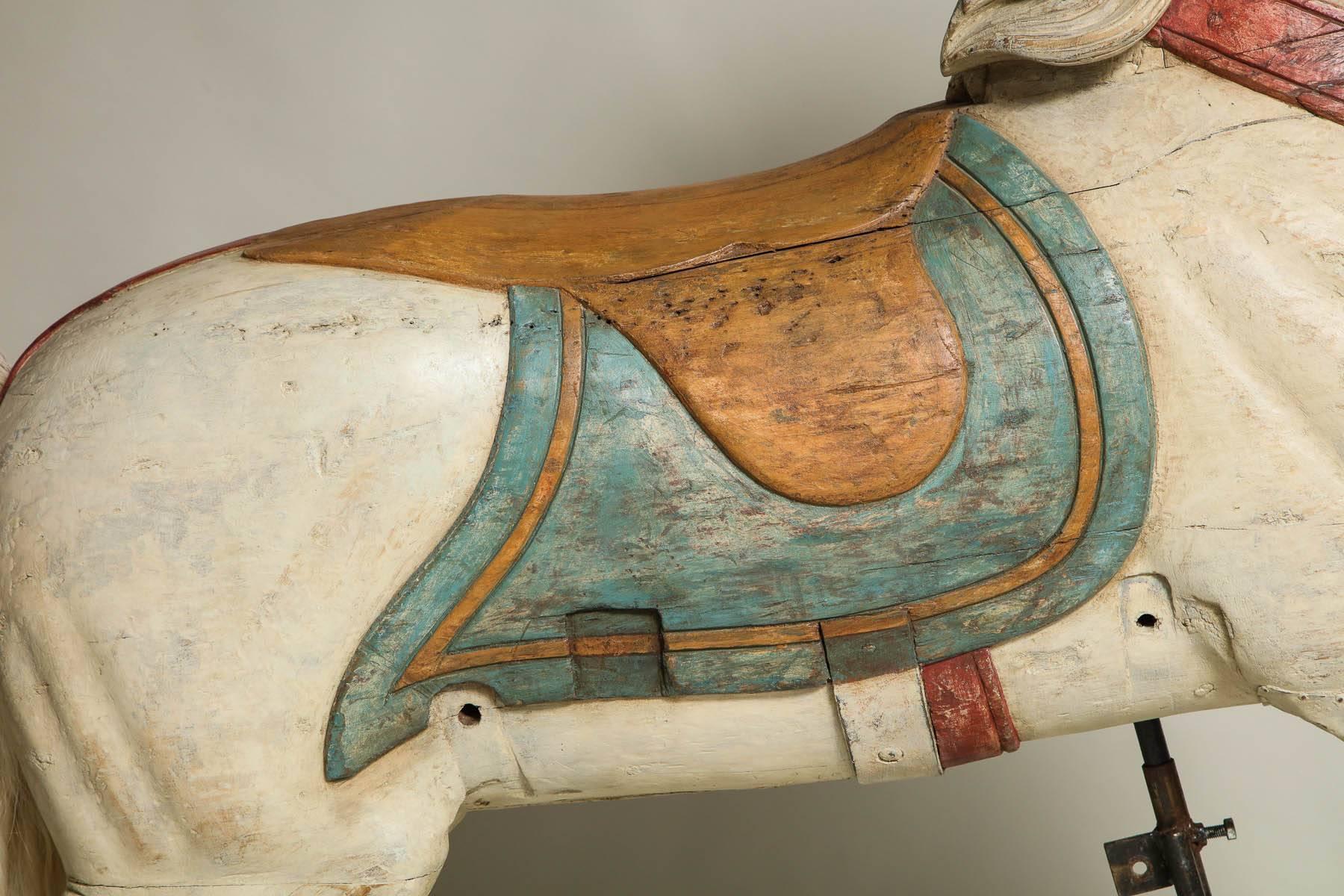 A carved and painted wood carousel figure of a white chahut horse with flowing main and hair tail by master carver Fredrich Heyn, Neustadt am Orla, Germany. Heyn was the leading German carver of carousel figures, and his work embodies the very best