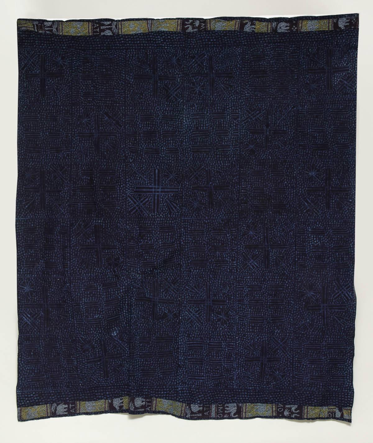 Rare dye-resist African cloth in wild raw silk with indigo dye having elephant border and
shaped star patterns to ground, Yoruba, circa 1960.
 