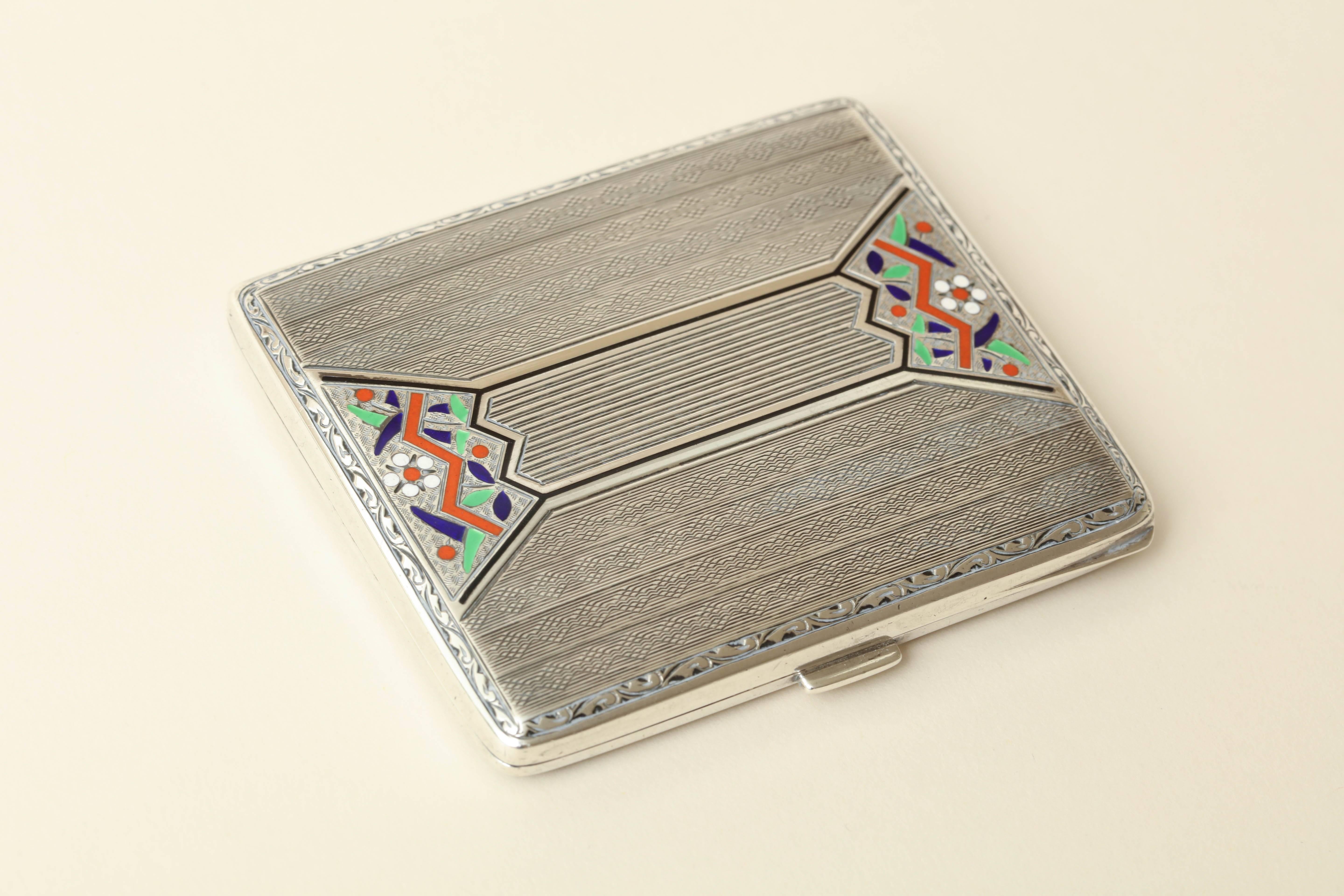 Measures: 3 1/4'' high; 2 11/16'' wide.
3.25 ozs.

Continental sterling silver cigarette case with champleve coral, blue, green, white and black enamel design.
Impressed for 925 silver/ imported and assayed at Birmingham/ 1928/ V.W. importers