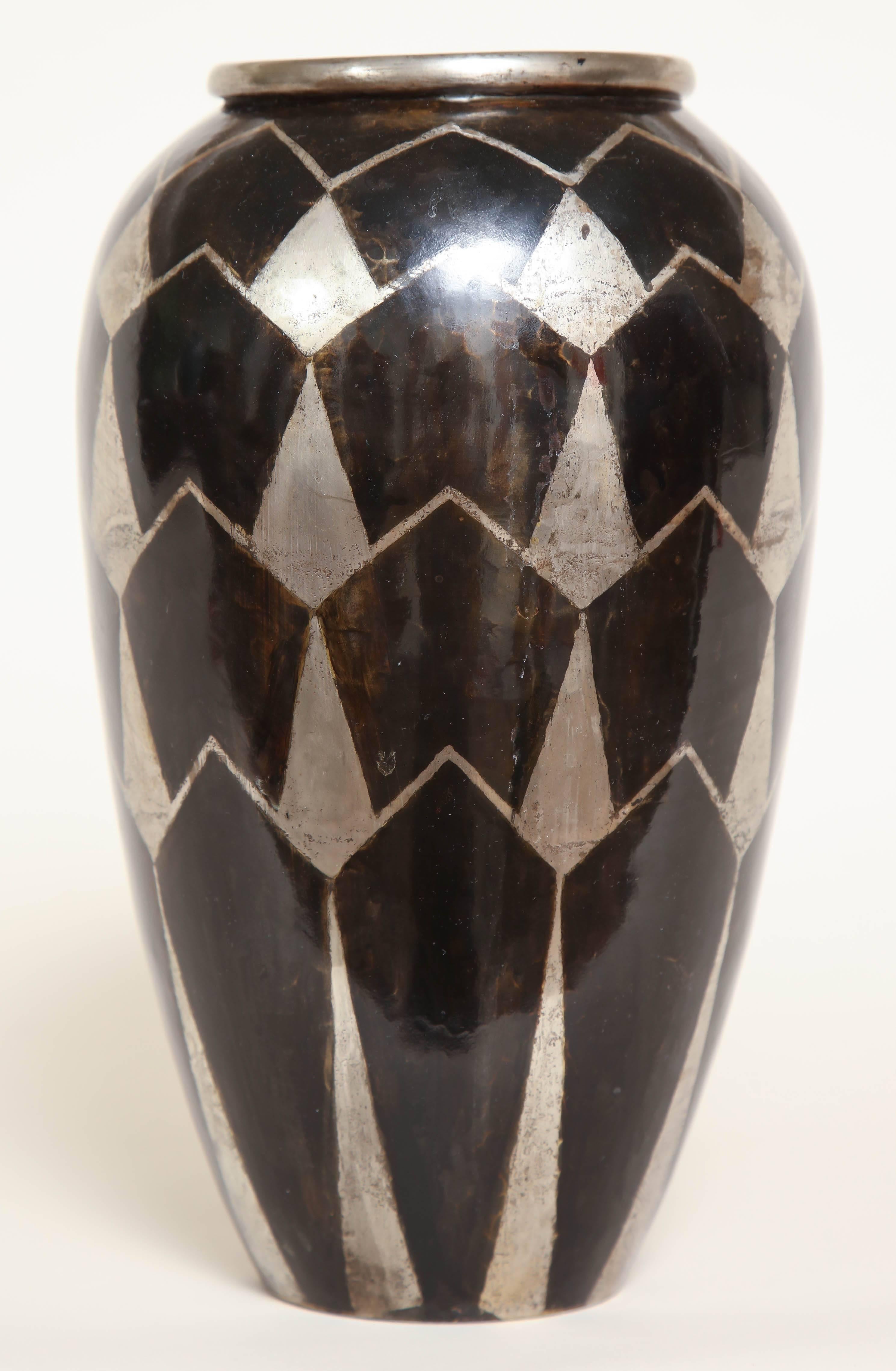 Dinanderie brass vase inlaid with silver in a geometric design.
Inscribed F Grange underneath.
  