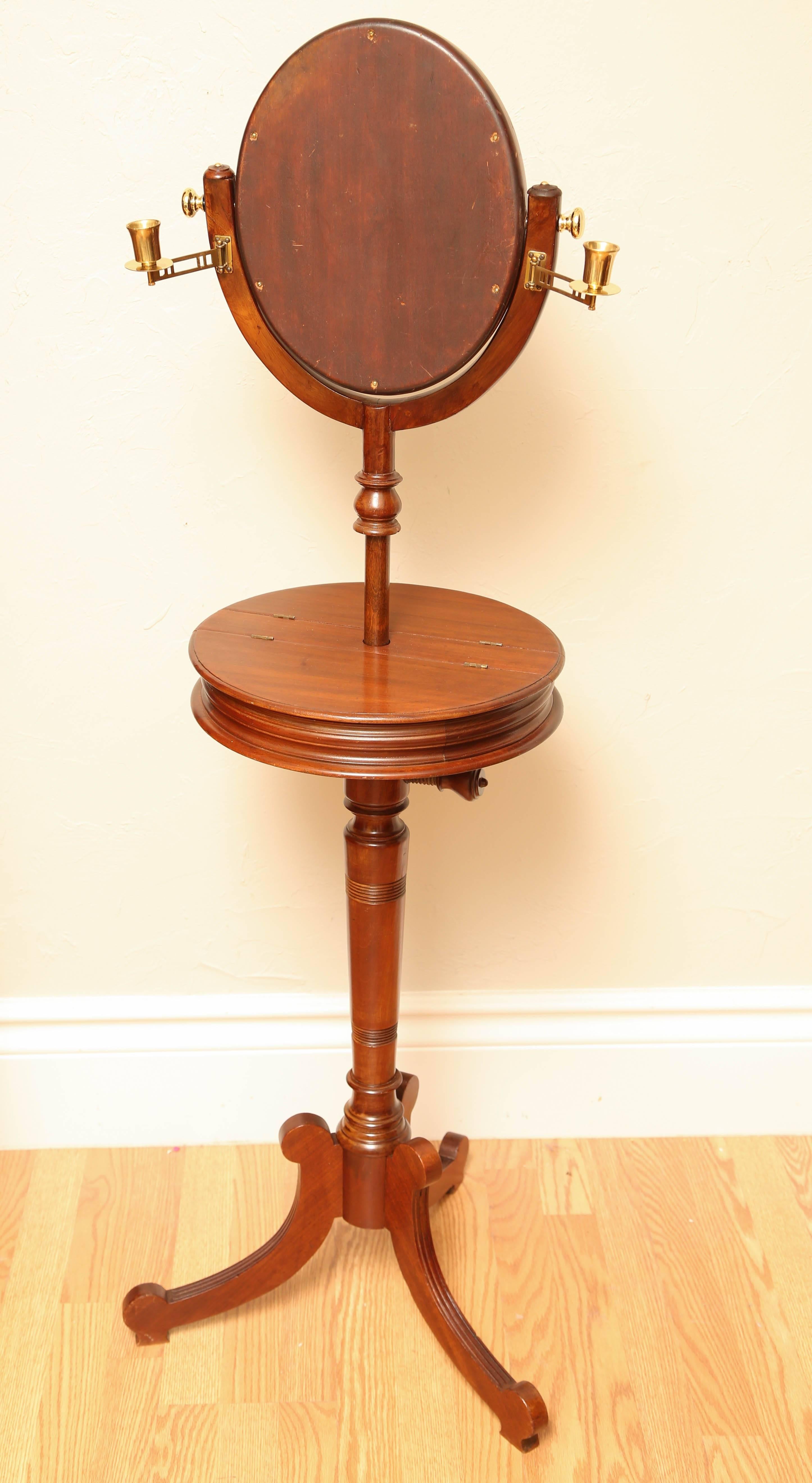 Antique shaving stand with tilting beveled mirror and two candleholders. The tabletop is 15