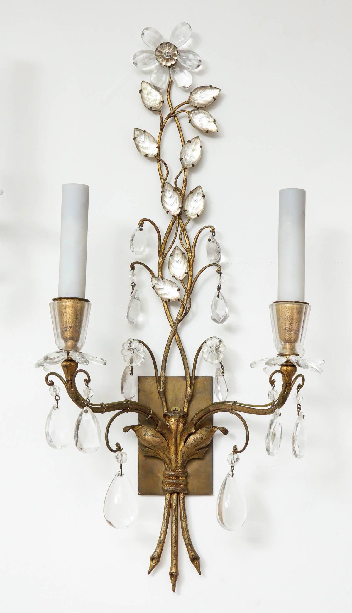 Pair of gracious French gilt metal and crystal floral sconces by Maison Bagues.
The sconces are in great condition and have been newly rewired.