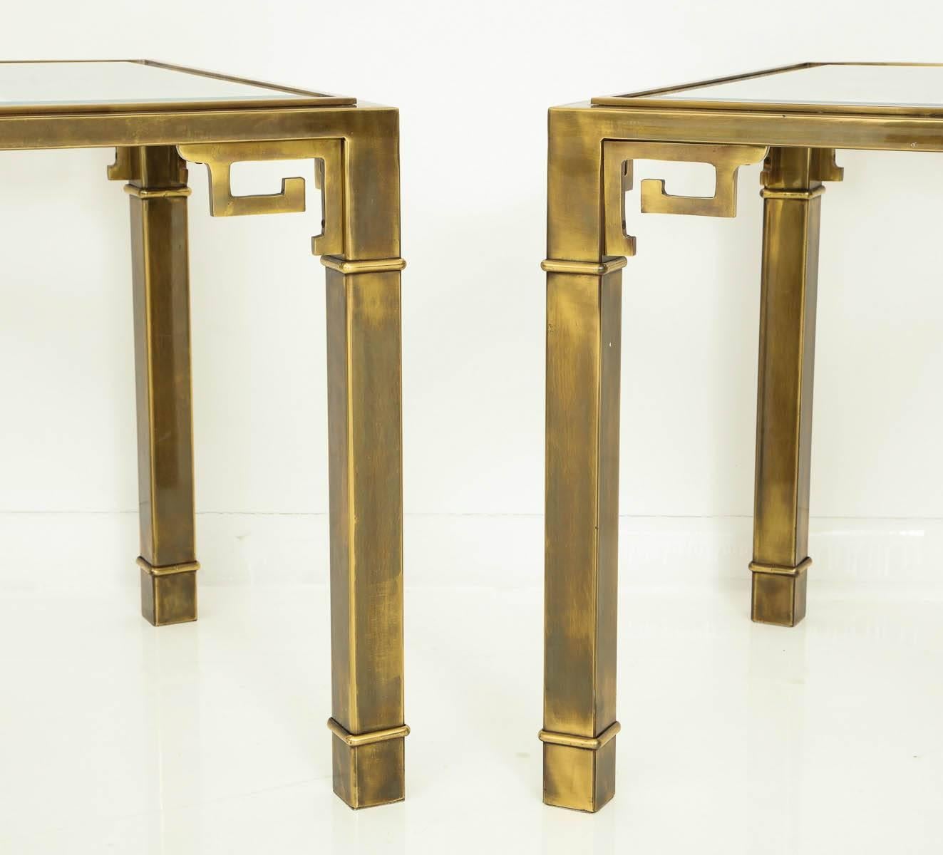 Pair of elegant brass side tables by Mastercraft.
The tables have Greek key detailing to the corners and have 1/4" inset glass tops.