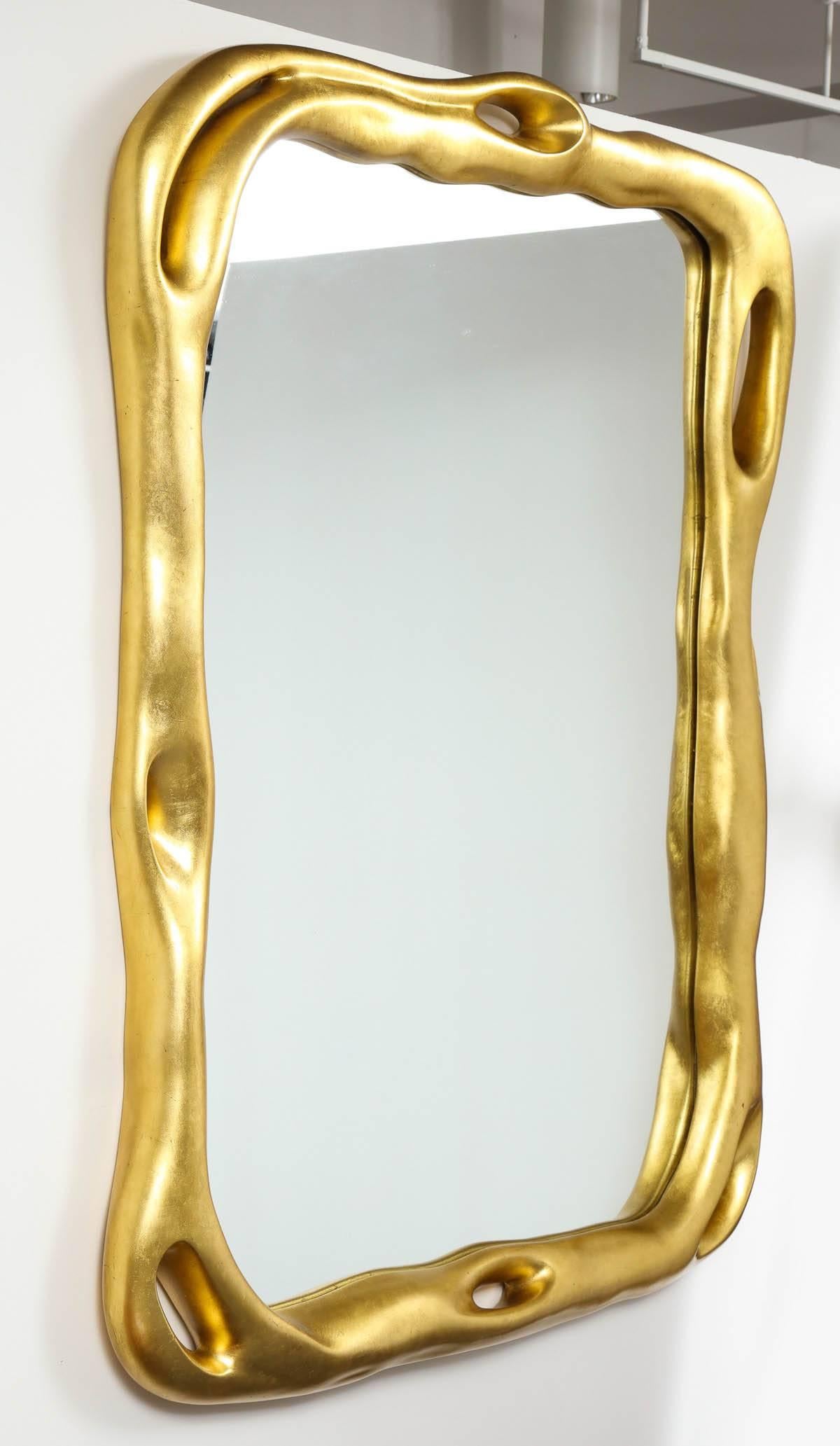 Fabulous Tony Duquette Mirror which was reissued by Baker in a limited edition.
The bold Biomorphic frame has a stunning gilt leaf finish and can be hung Horizontally or Vertically.
 