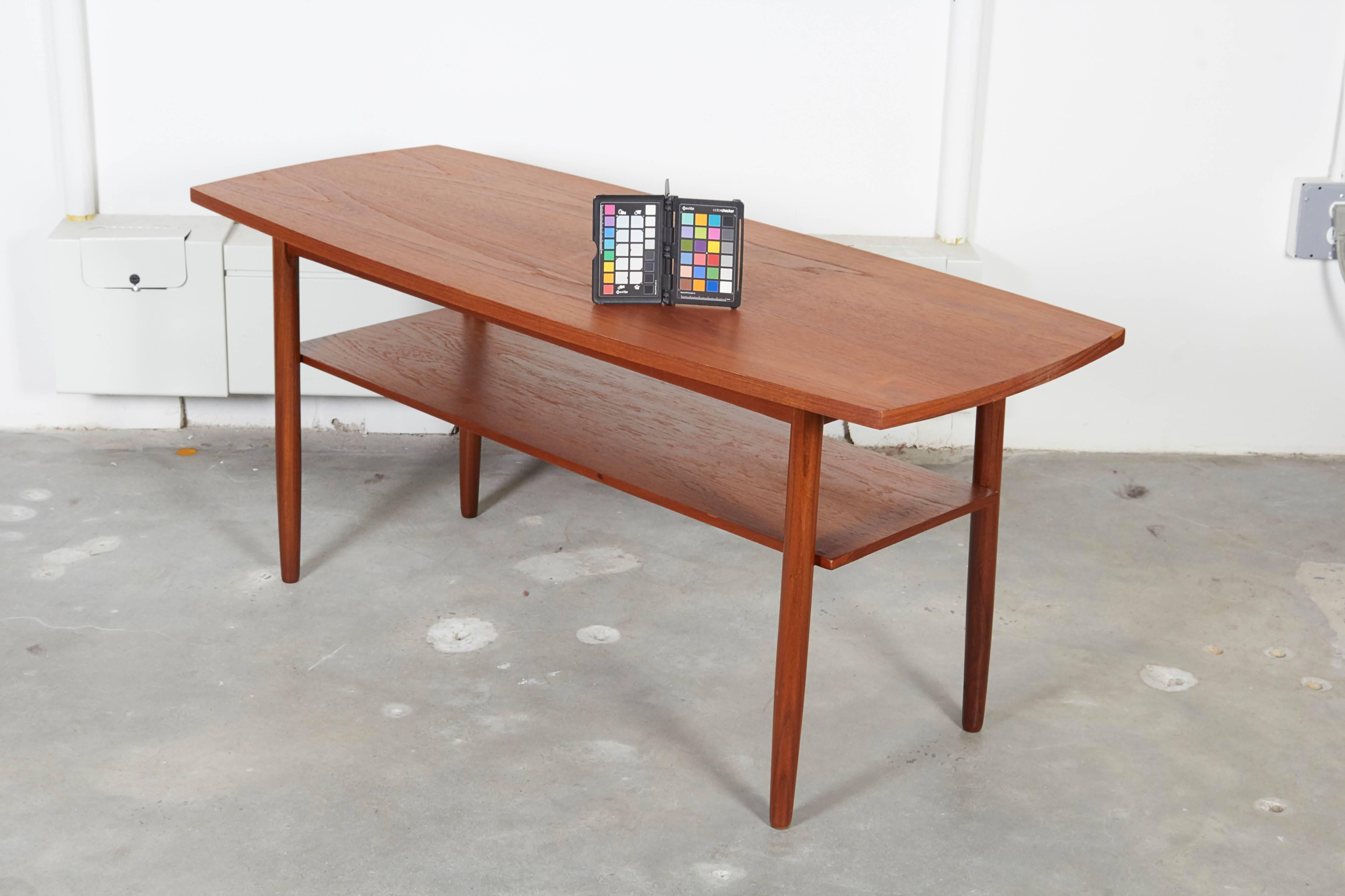 Vintage 1960s Danish Teak Coffee Table

This surfboard coffee table is in excellent condition. The bottom shelf and small size make it a perfect fit for any living room. Ready for pick up, delivery, or shipping anywhere in the world. 
