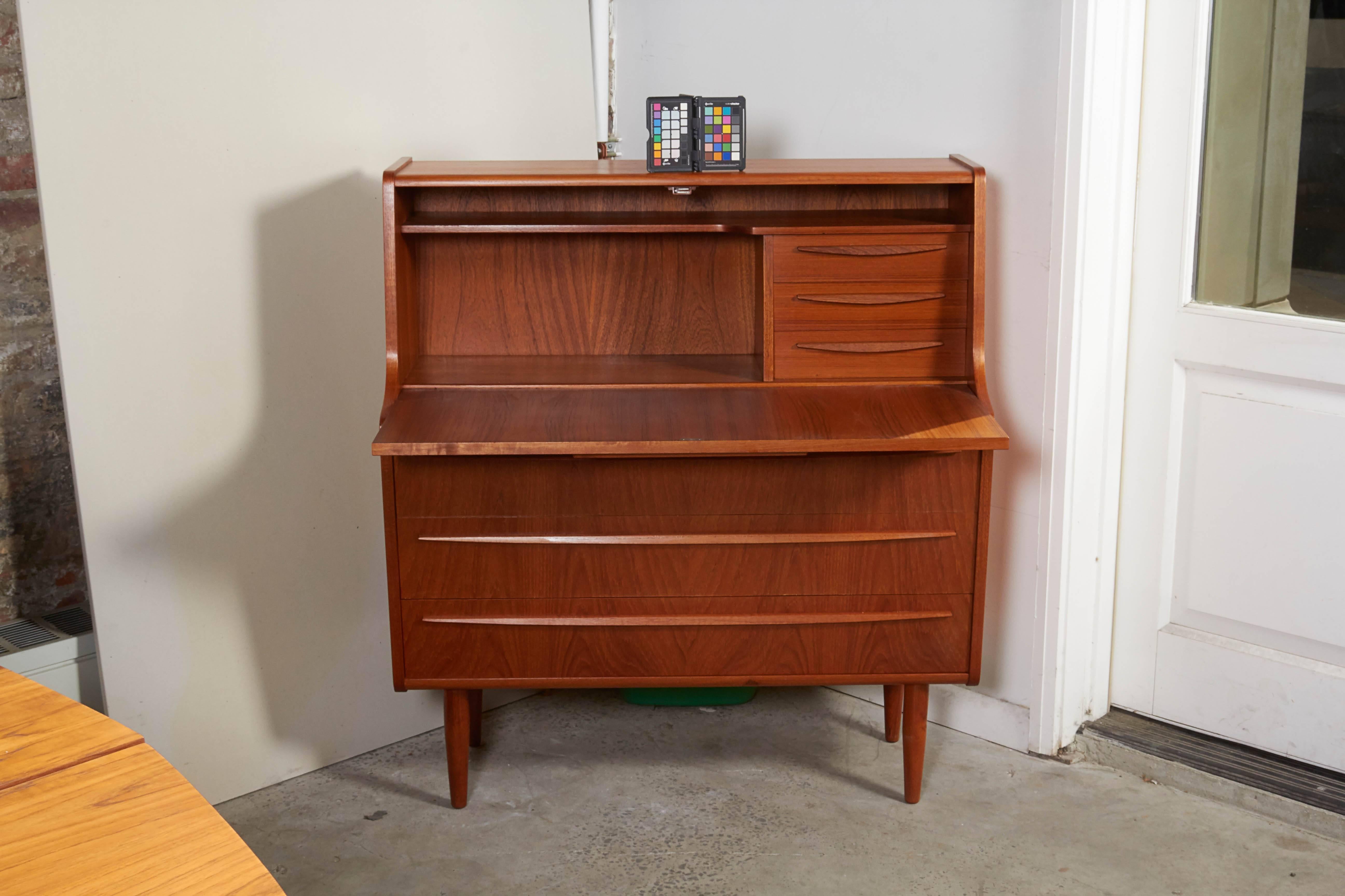 Vintage 1960s Danish Secretary Desk & Dresser

Excellent for use in a bedroom or guest room. The drawers are dresser size and the desk is a big added bonus. Small enough for any room. The depth of the secretary when the desk is pulled out is