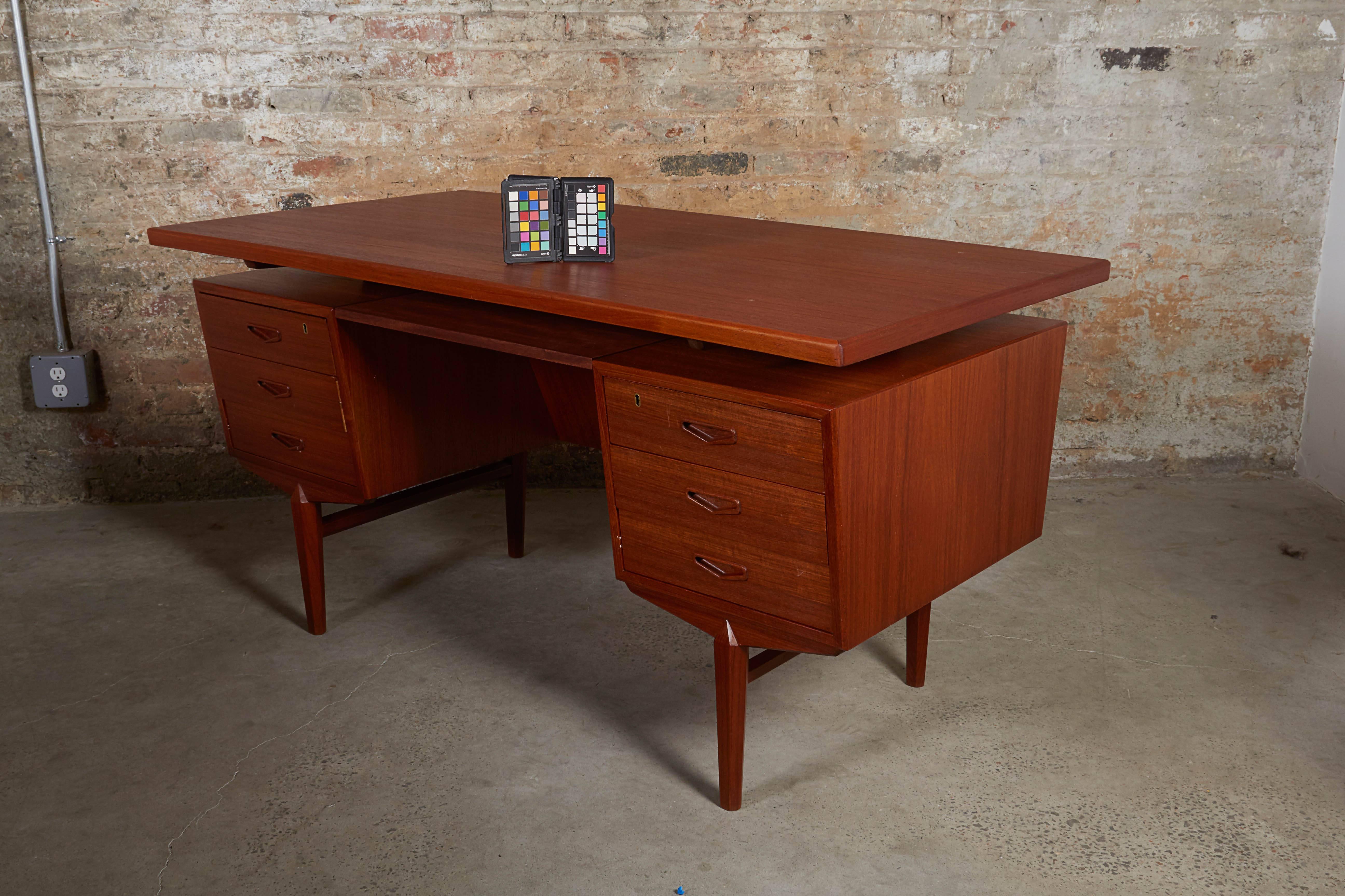 Mid Century 1960s Teak Desk

This vintage desk from Denmark is in excellent condition. 6 drawers and a filing cabinet on the back make this desk great for home or for that corner office. Ready for pick up, delivery, or shipping anywhere in the