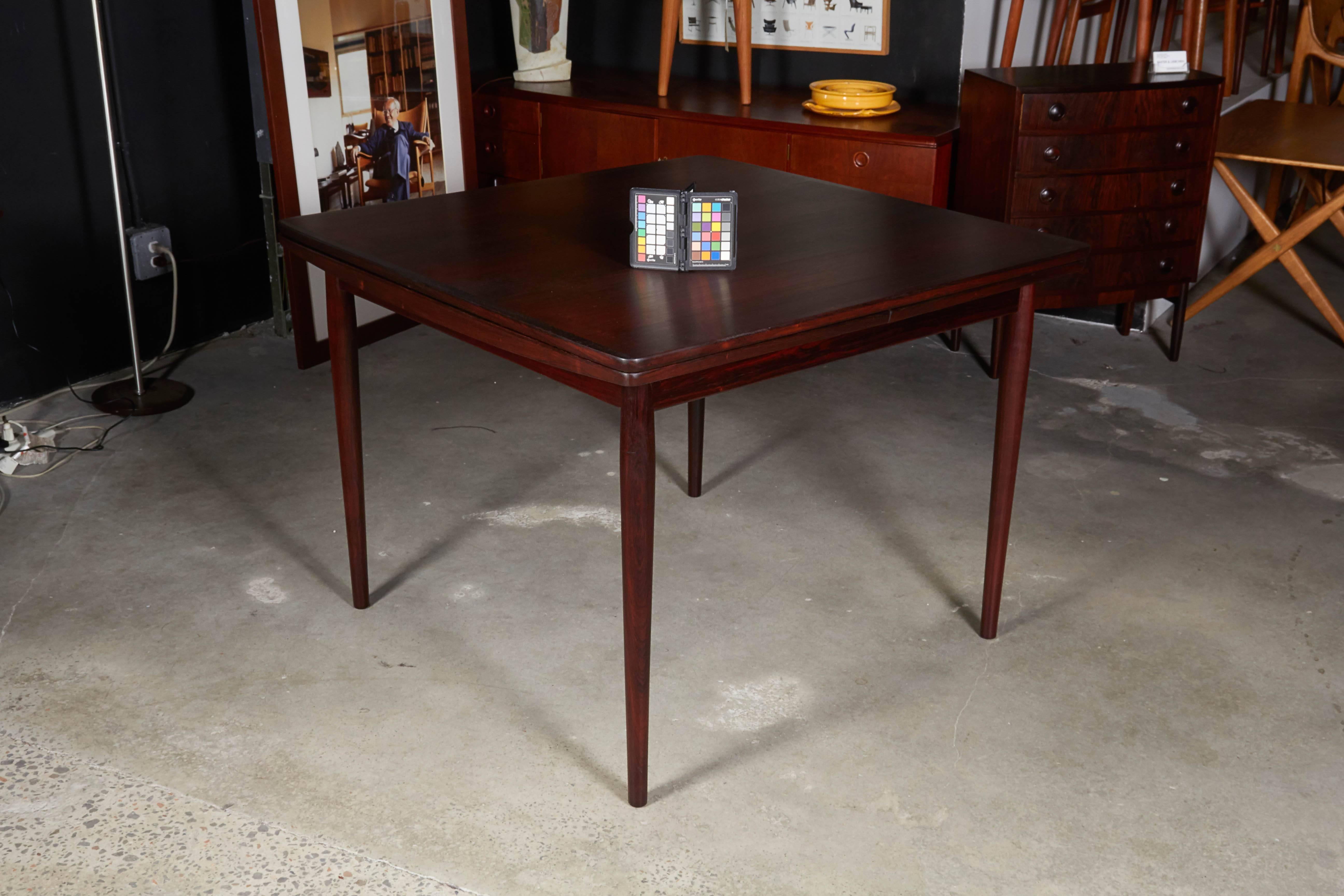 Vintage 1960s Kurt Ostervig Dining Table with 2 Leaves

This mid century dining table is in excellent condition and is one of the most beautiful I've seen in a long time. The leaves that pull out from under the table are large at 19"; seats 8