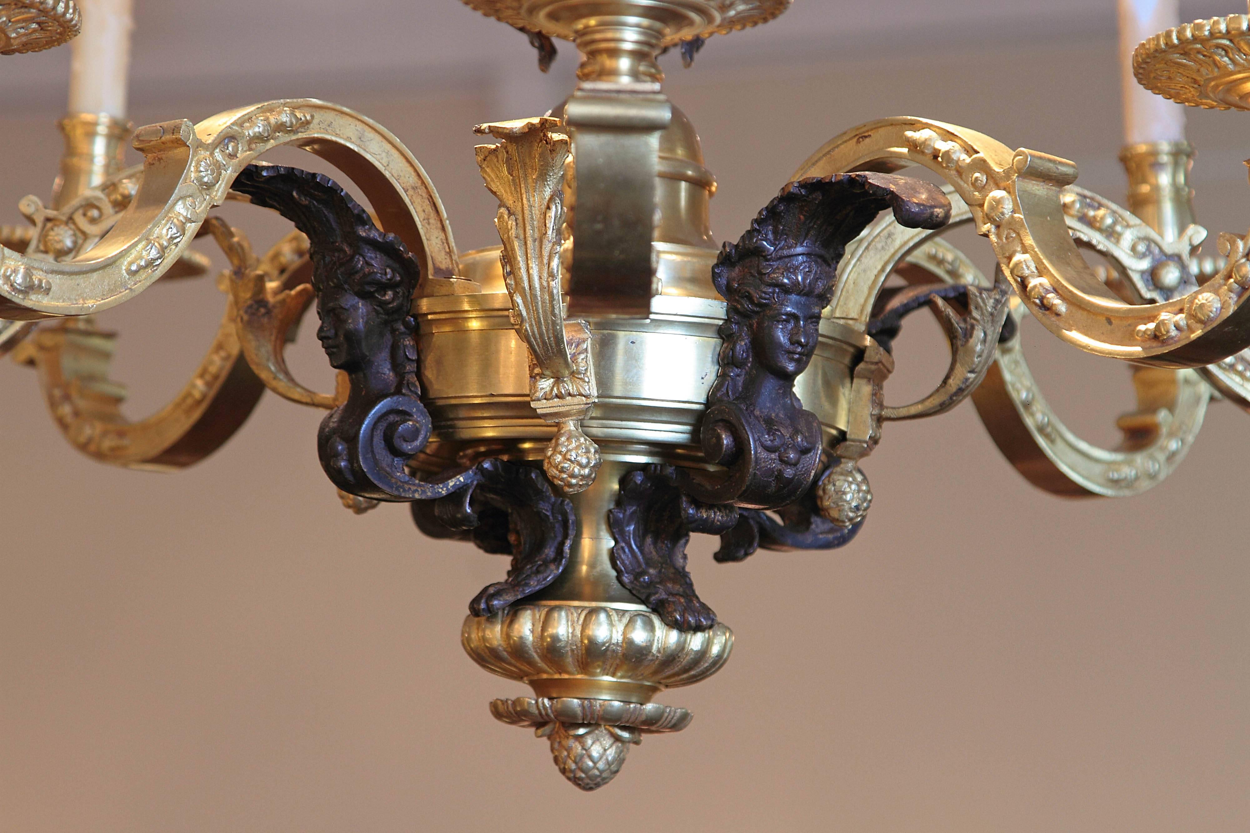 19th century French Regence gilt bronze and patinated bronze chandelier. Cherub heads.