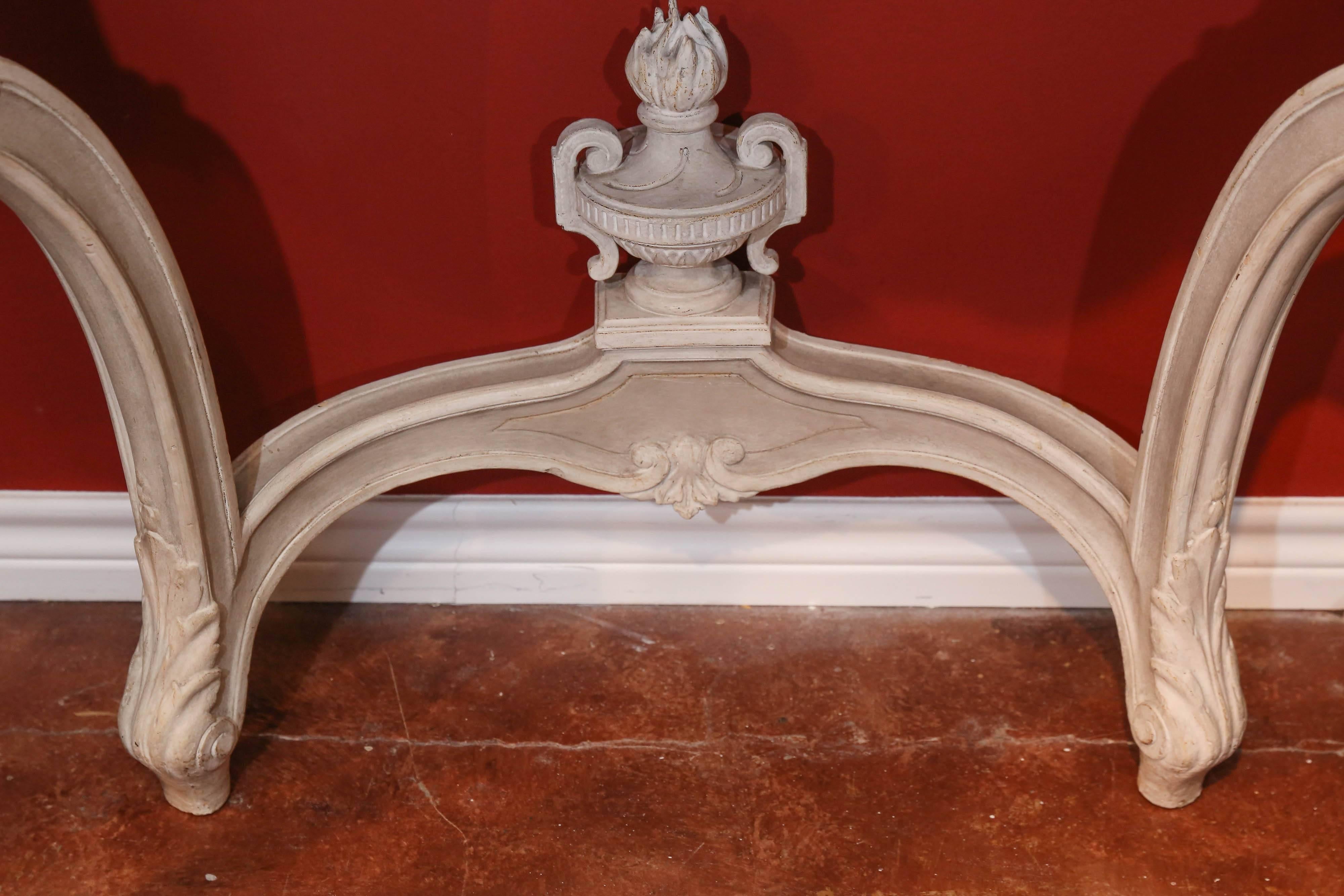 Beautiful pair of wall attached consoles painted in a cream/gray finish
having marble tops in a variegated gray and white color. Serpentine
leg in a Louis XV transitional foot. All in very good condition. The front
is carved in a lovely shell