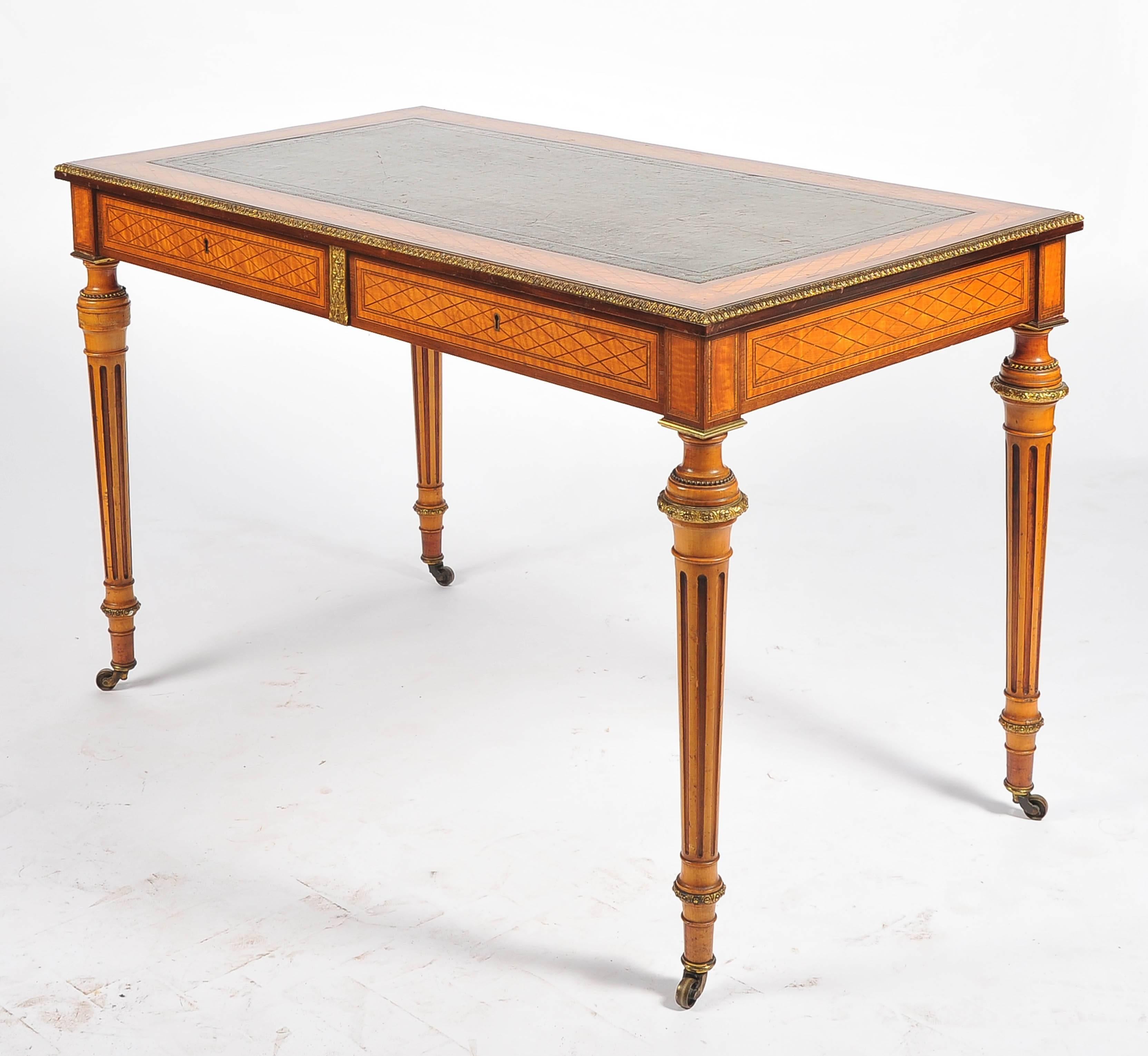 A fine quality satinwood parquetry inlaid library table. Having an inset leather top, gilded ormolu mounts. Two frieze drawers and raised on turned tapering fluted legs, terminating in the original brass castors.
Attributed to Donald Ross.
 