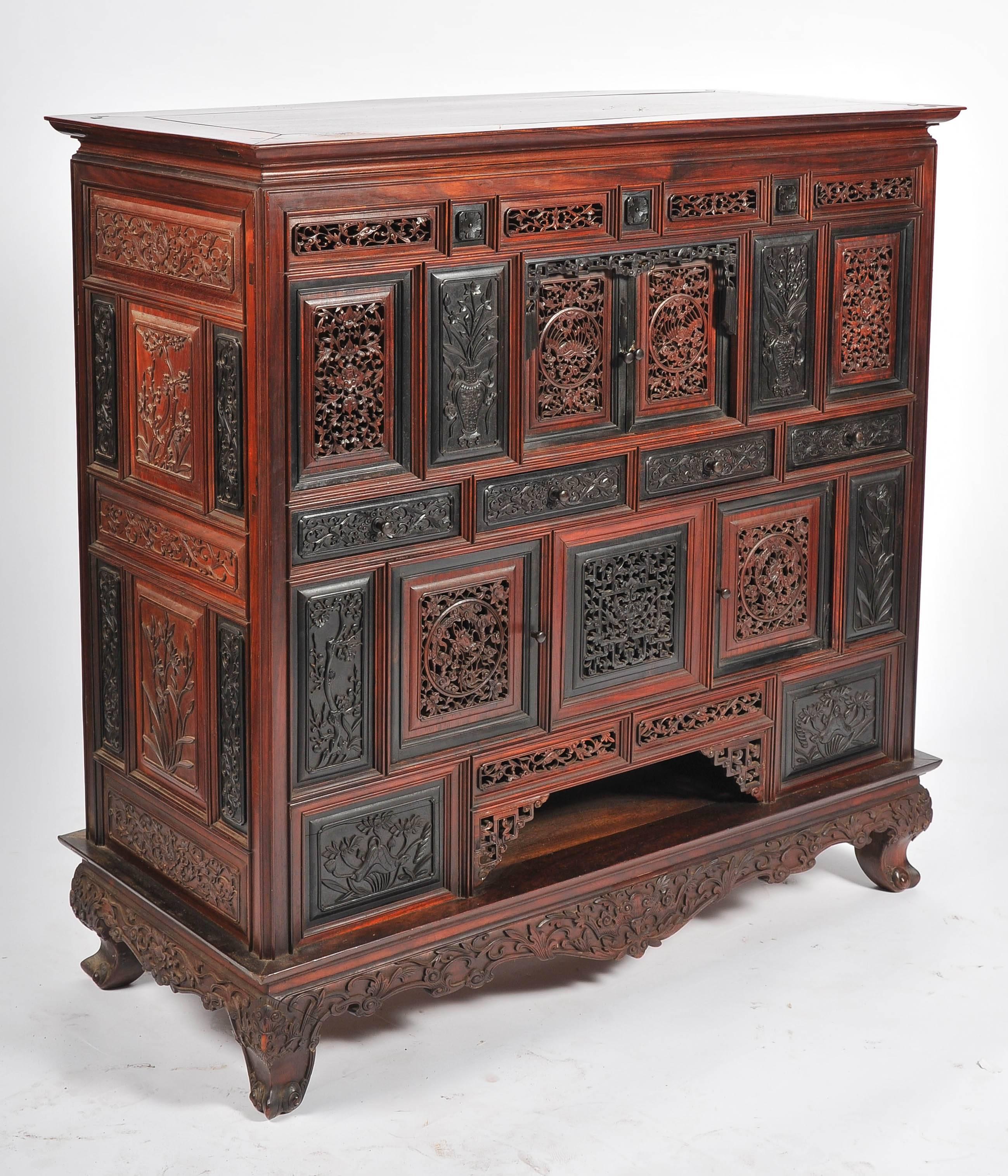 A fine quality 19th century Chinese hardwood cabinet. Comprising of carved doors and drawers of foliate decoration, set between fretwork panels and doors. Raised on a base with small carved cabriole legs with an apron between.