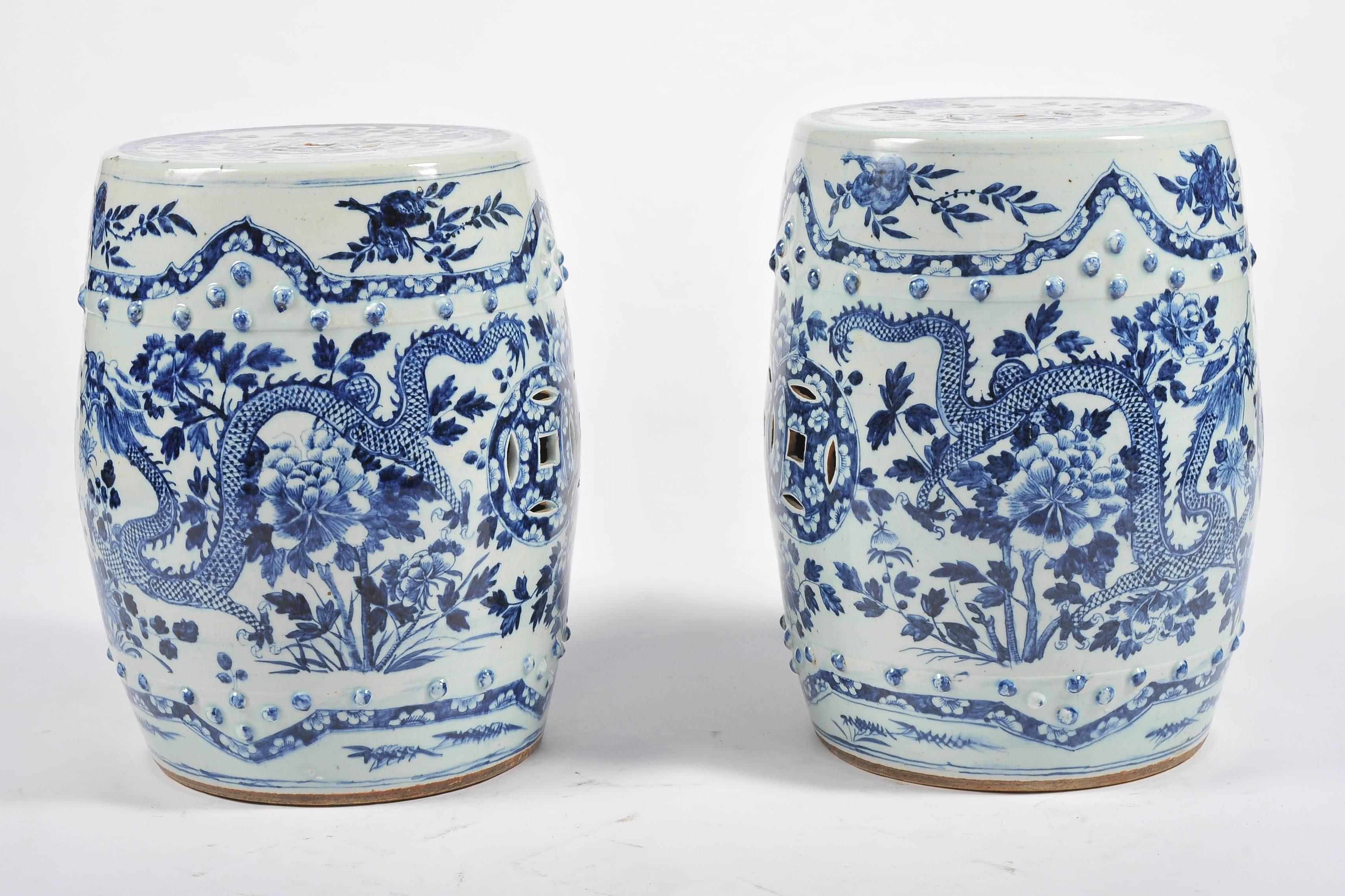 A good quality pair of 19th century Chinese blue and white garden seats. Each having pierced roundels to the top and sides. Mythical dragons painted amongst flowers and foliage.