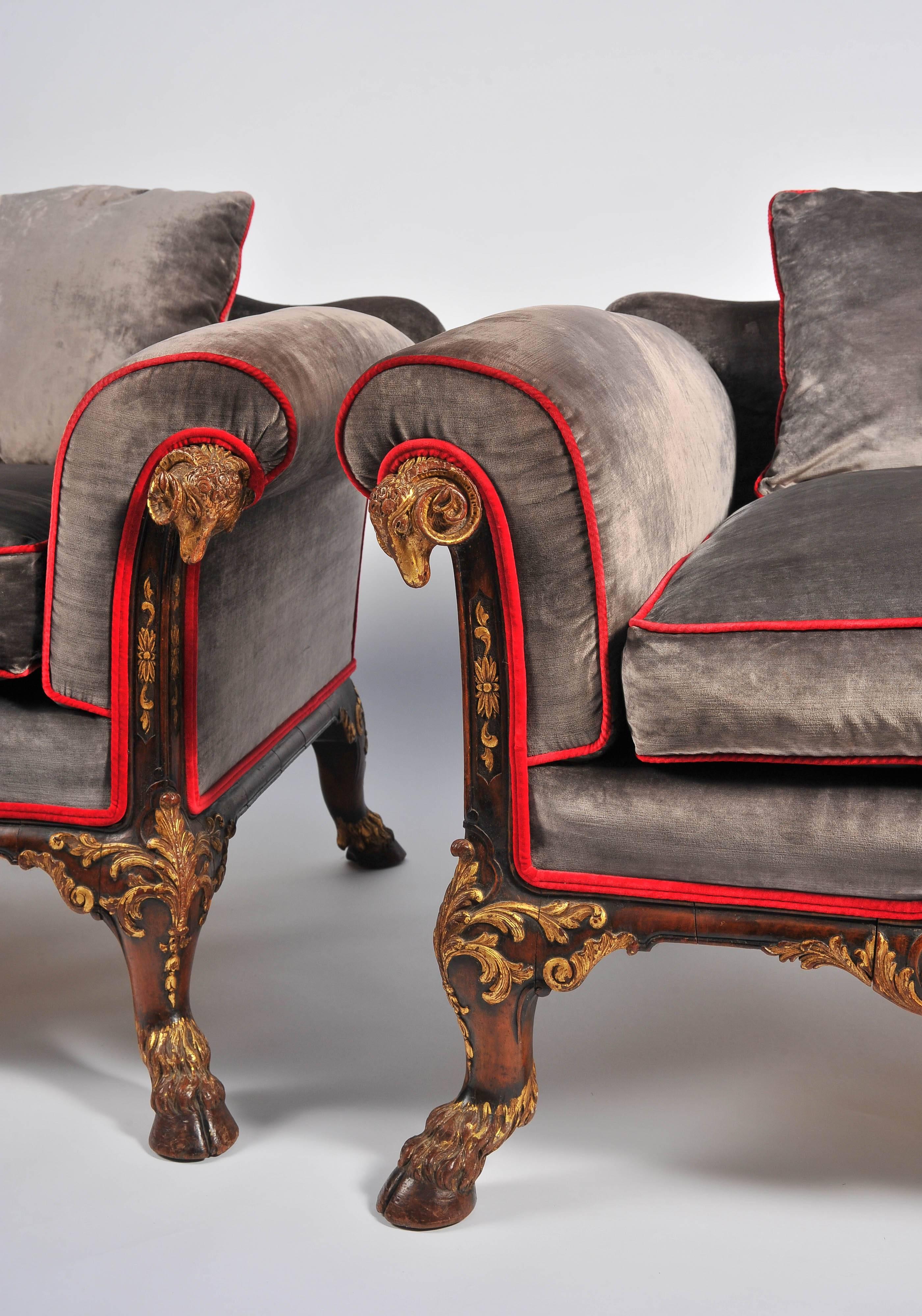 A very good quality classical antique style walnut Bergere sofa and two armchairs. Having carved gilded Rams heads, stuff over upholstery with scatter cushions. Raised on carved C scroll decoration and hoof feet.