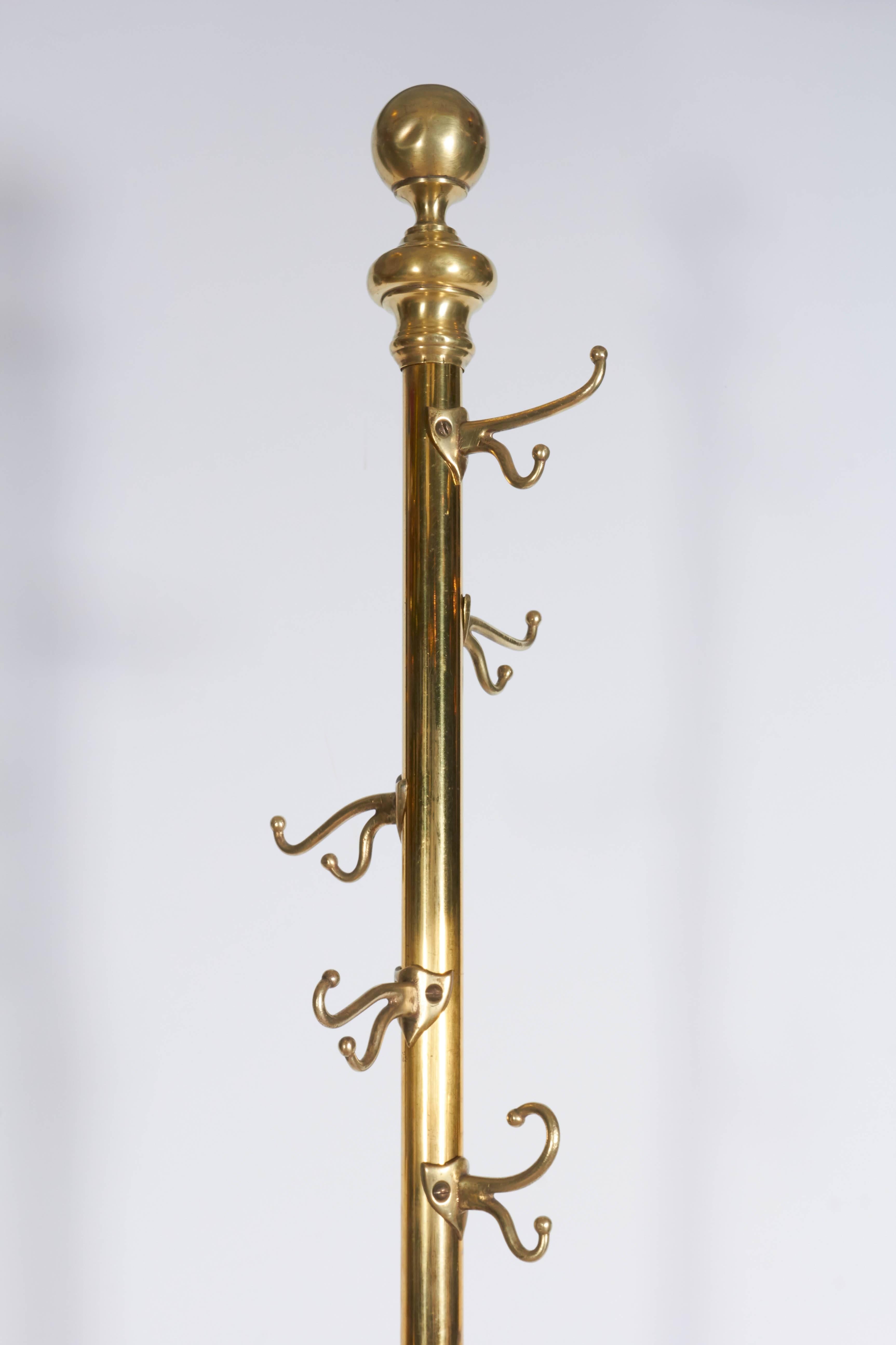 An Italian polished brass coat rack, produced within the Victorian period, circa 1880s, surmounted by ball finial, scroll hooks to stem, raised on elaborate tripod base with hairy paw feet. Excellent antique condition, wear consistent with age and