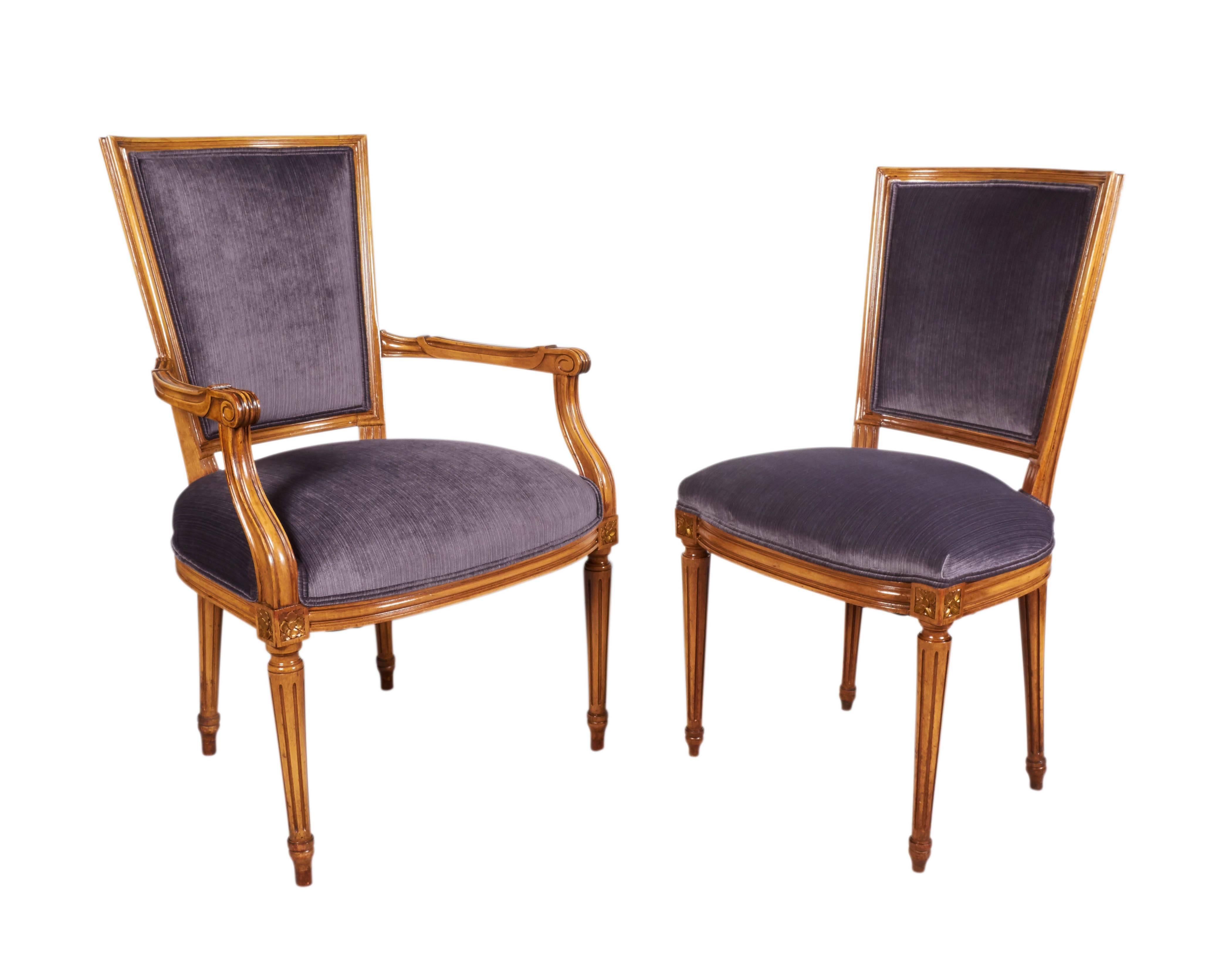 A set of six Louis XVI style dining chairs by Maison Jansen, comprising two-arm and four-side, produced in France, circa 1940s, each with backs and seats upholstered in lavender grey colored strie velvet, against carved wood frames. Excellent