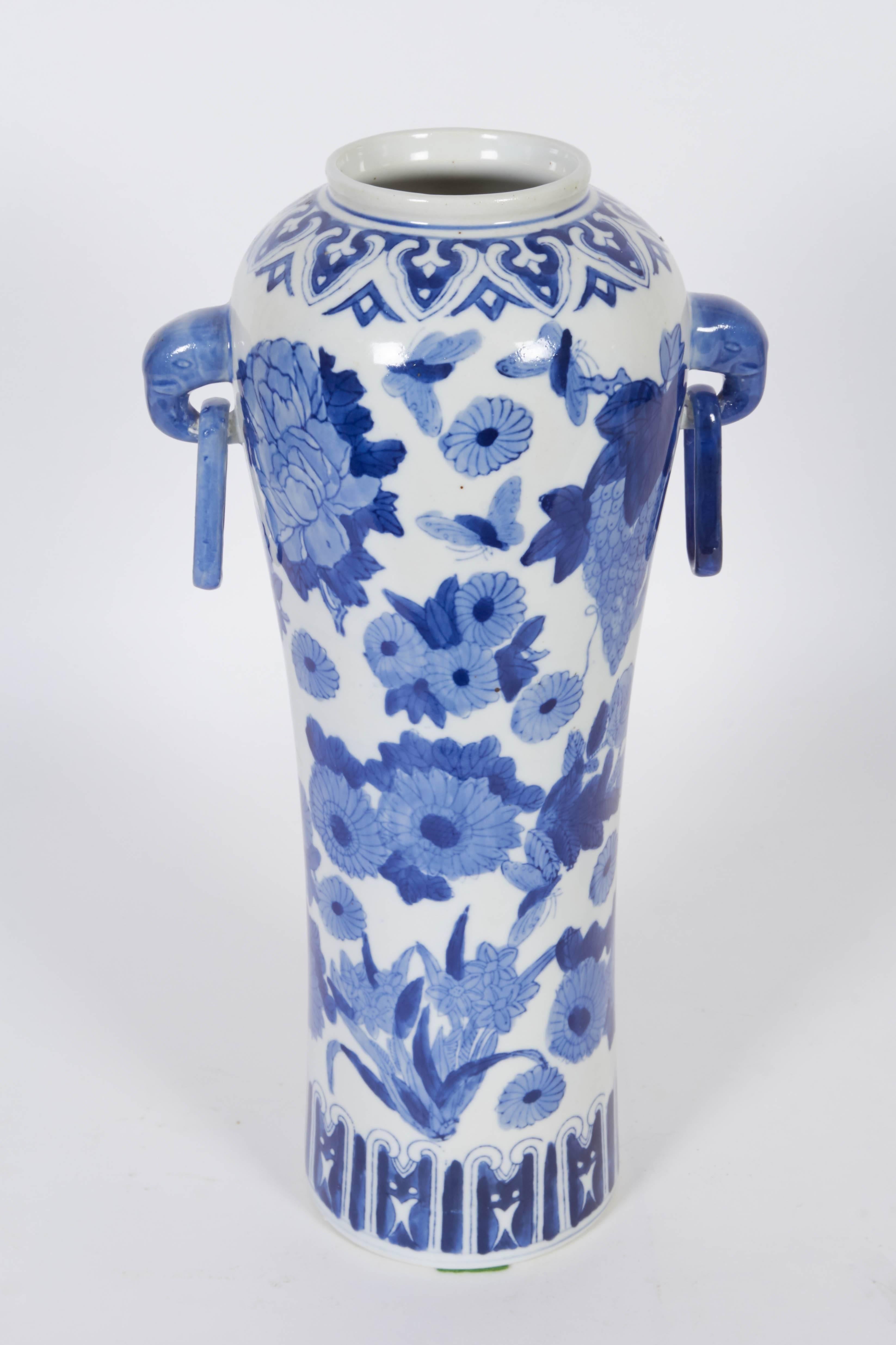 A pair of Chinese late 20th century tall meiping style vases with ring handles, in blue and white porcelain with floral decoration; bearing marks. Very good condition, consistent with age and use.

110499