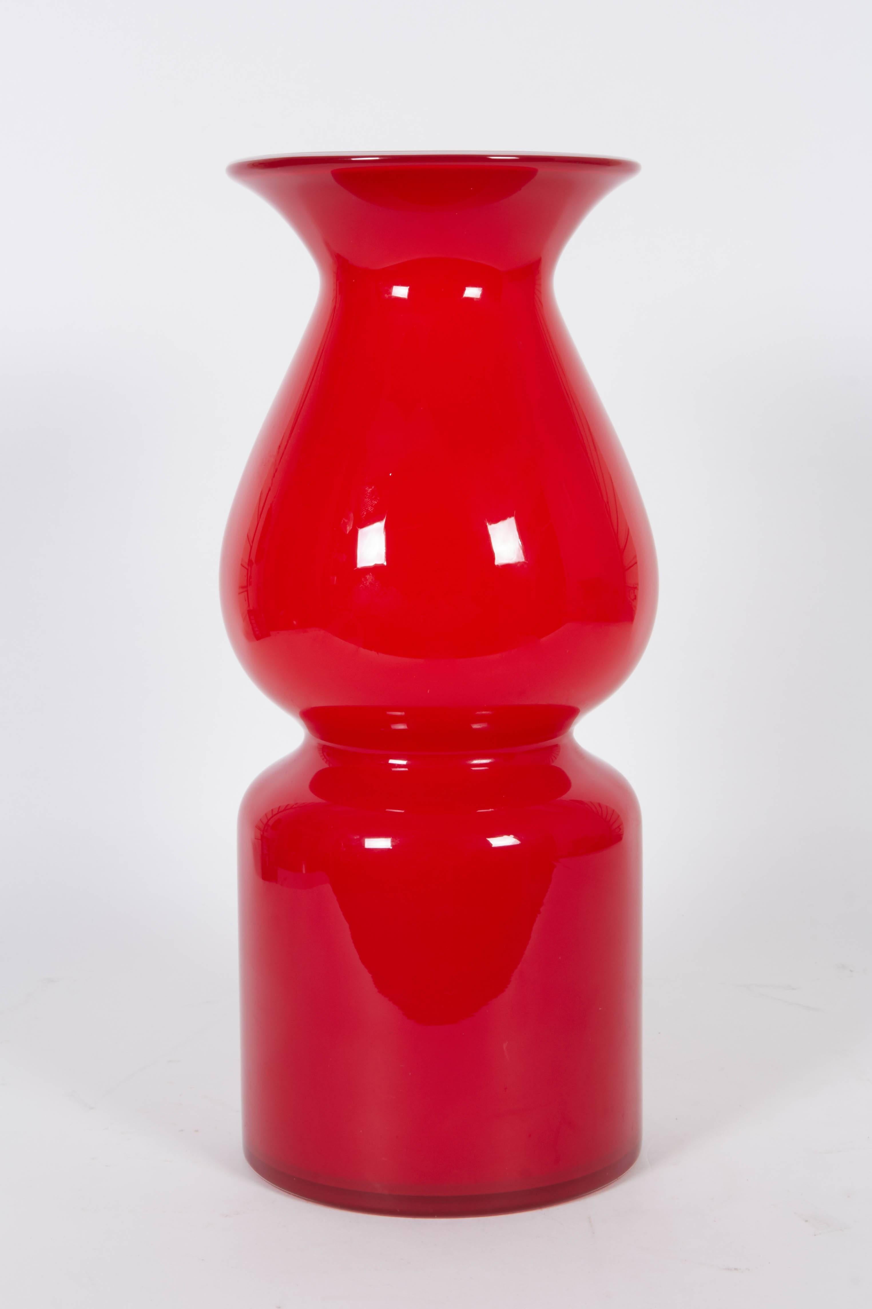 A Mid-Century Era vase designed in the manner of Per Lutken's 'Carnaby' line for Holmegaard, produced in Austria circa 1960s, of baluster form with flared rim in red cased glass. Excellent condition, consistent with age and use.

11062