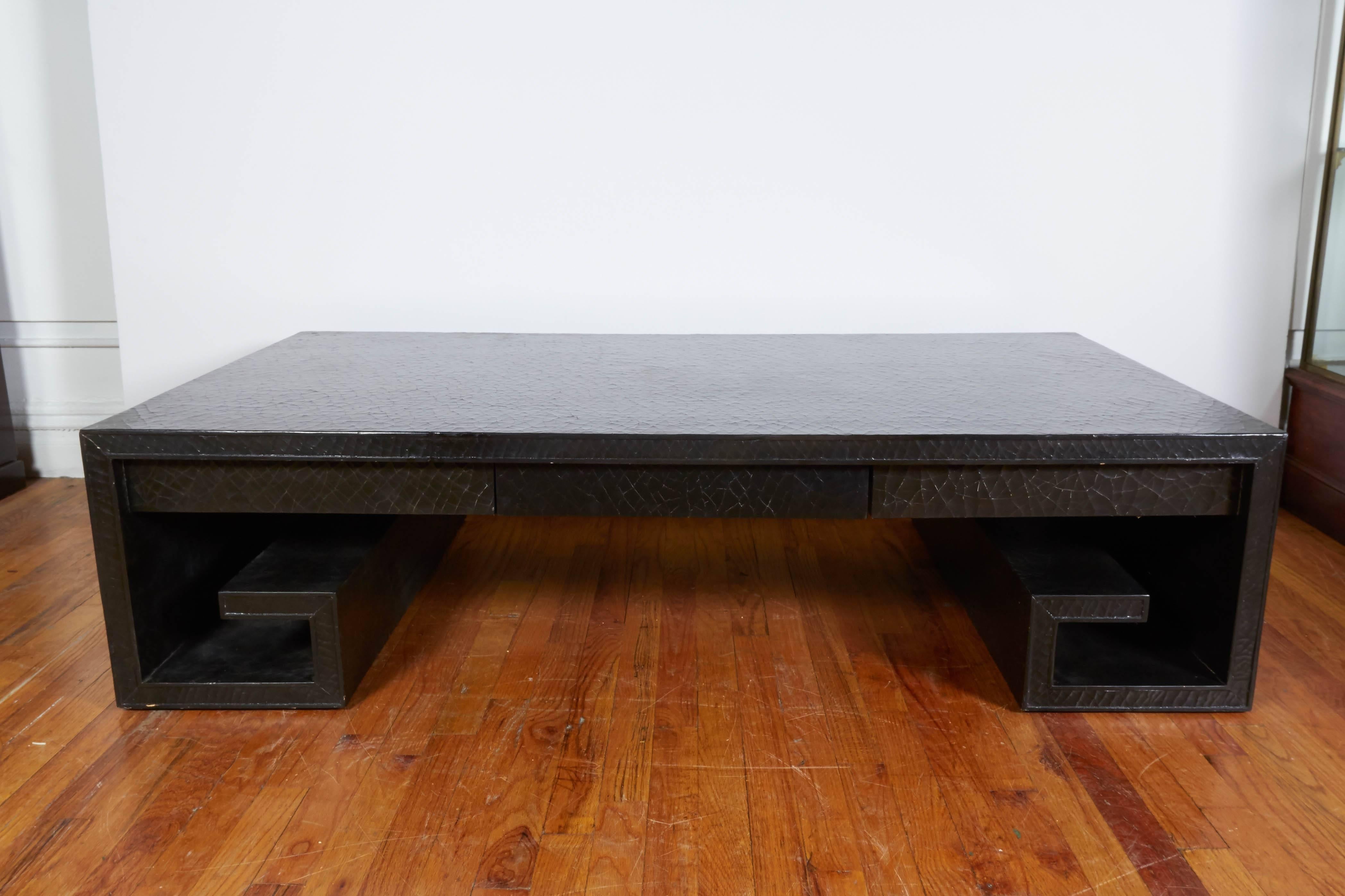 A Greek key scroll form coffee and cocktail table designed by Thomas Pheasant, manufactured circa 1970s by Baker Furniture Company, entirely with black lacquer finish with crackle detail, with single exterior drawer. Markings include maker's label