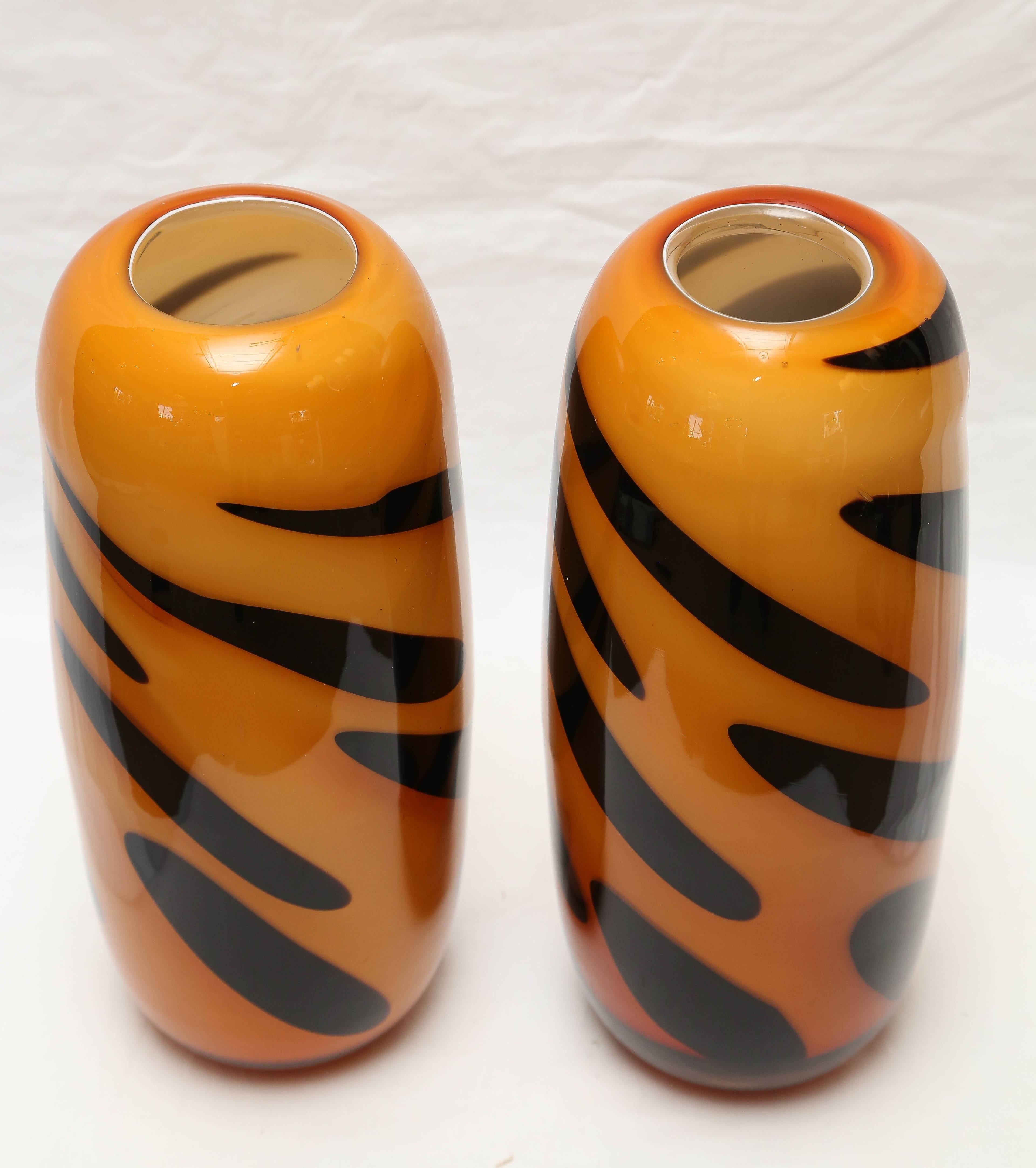 Pair of Seguso vases with tiger stripe motif. Deep orange and black in heavy Murano glass.