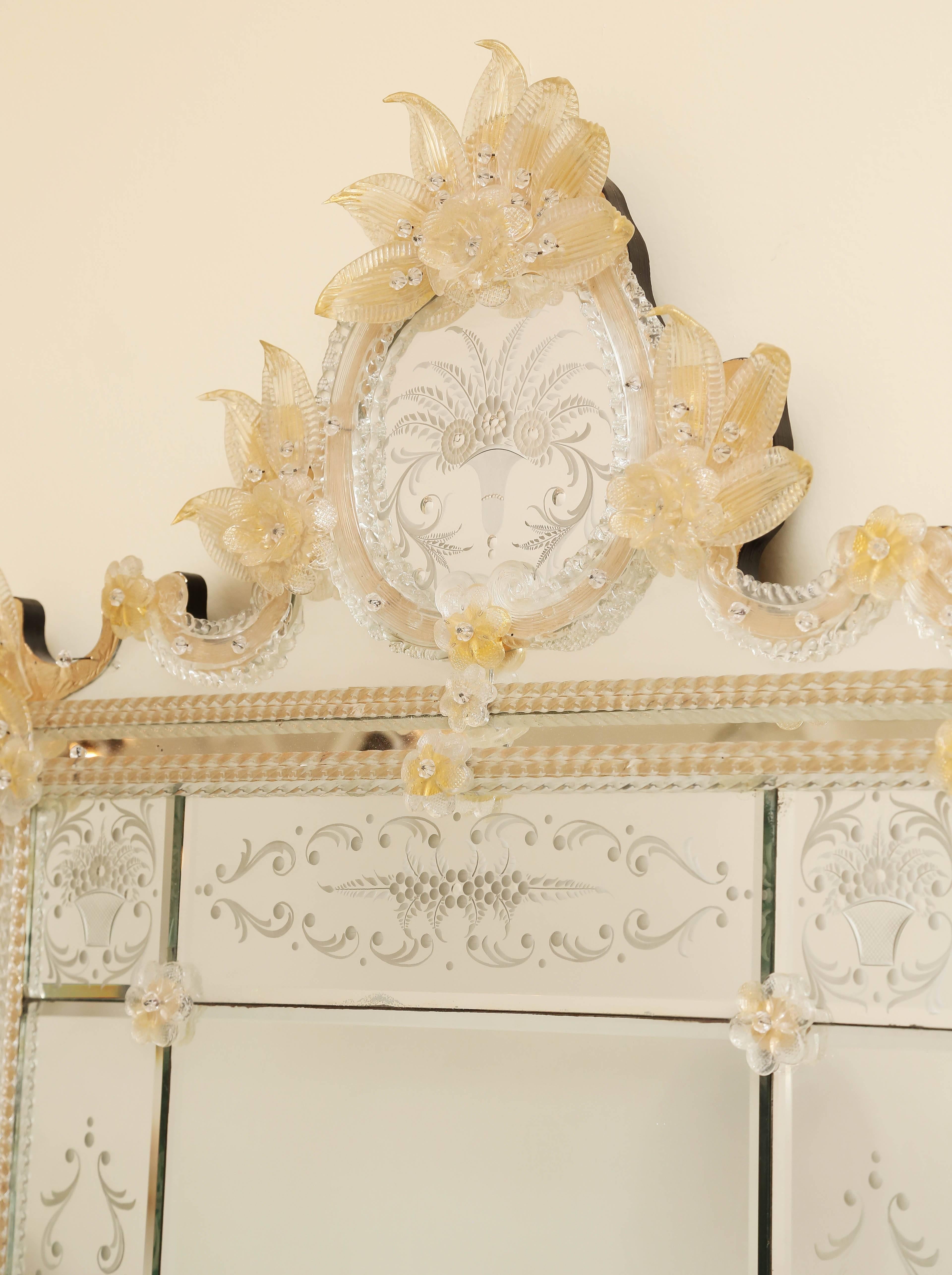 Fabulous Venetian mirror ornate etched with Bohemian gold dust flowers and leaves surrounded by twisted Murano glass flutes.
 