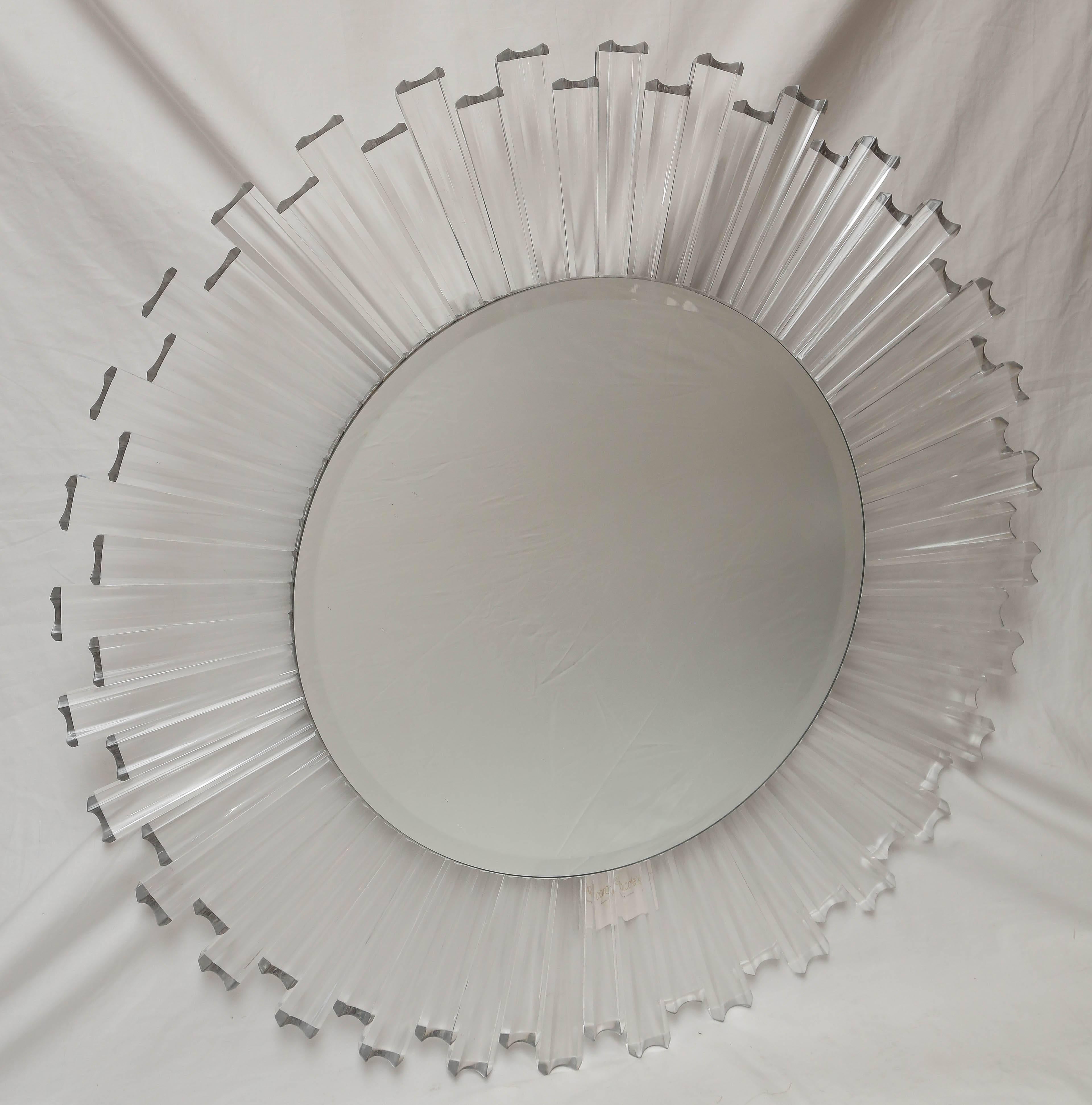 A sunburst mirror with individual connected Lucite pieces to a round circle.
The mirror diameter is 24.25 inches.
The original tag is still attached.
It has a huge hanging construction on the backside for a safe and secure display.