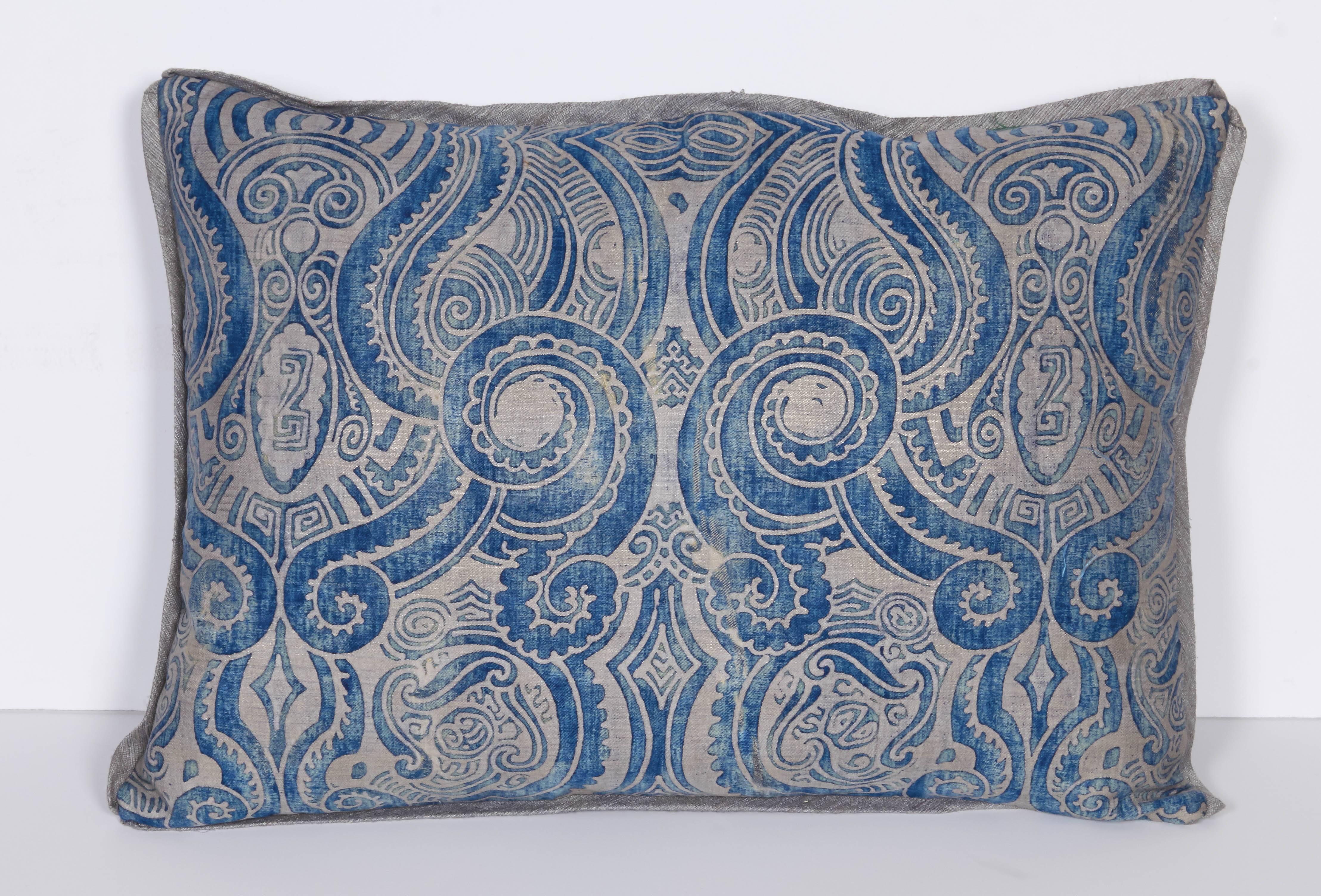 A pair of Fortuny fabric lumbar cushions in the Peruviano pattern, silk bias edging and peacock blue taffeta backing, the pattern, a Mayan inspired design with scroll motif. Newly made using vintage Fortuny fabric, circa 1920.
50 down/50 feather