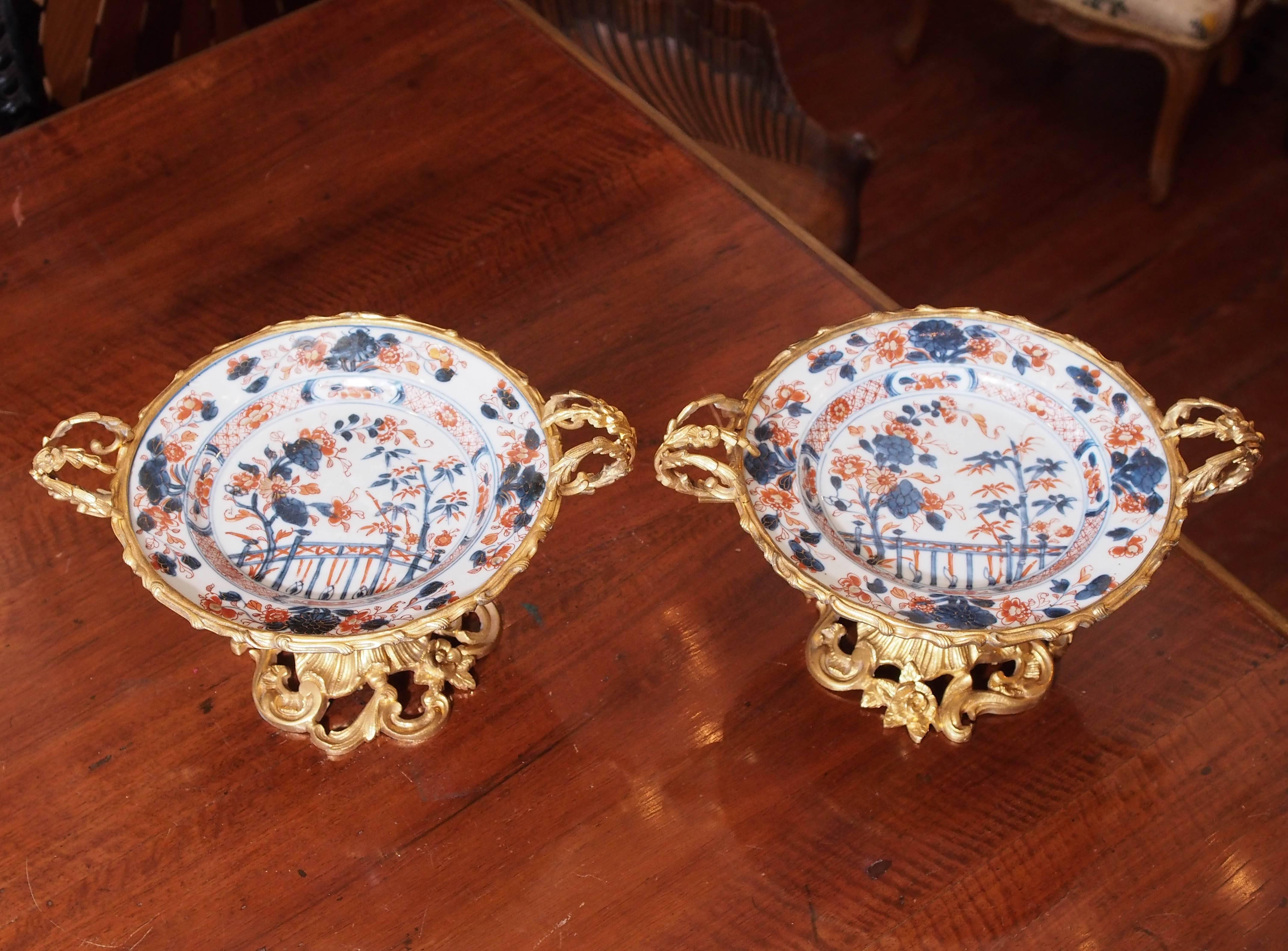 Pair of French gilt bronze-mounted Japanese Imari plates having foliate mounting. Mounts are 19th century and plates are 18th century.