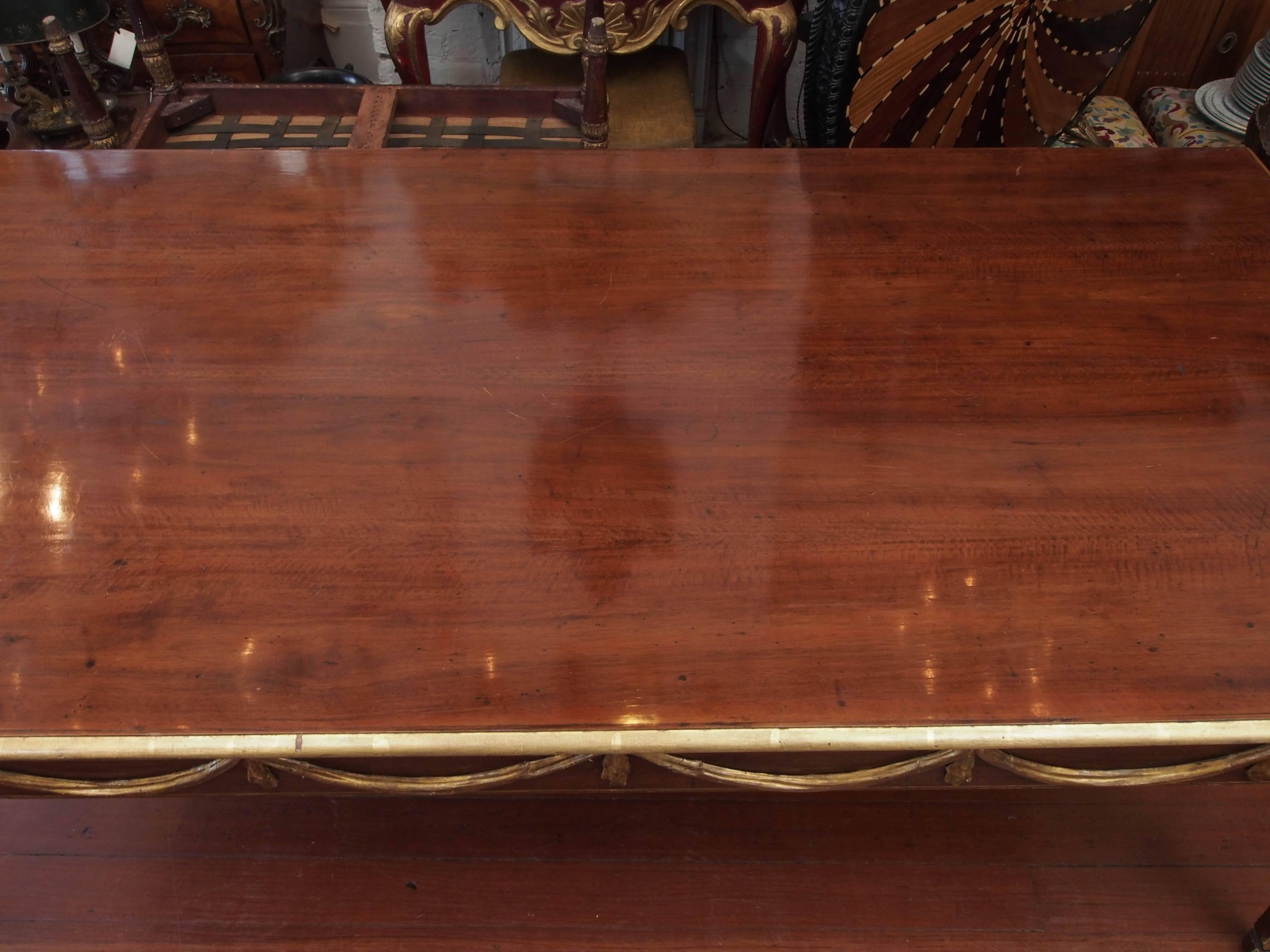 Italian Louis XVI mahogany and parcel-gilt dining table.