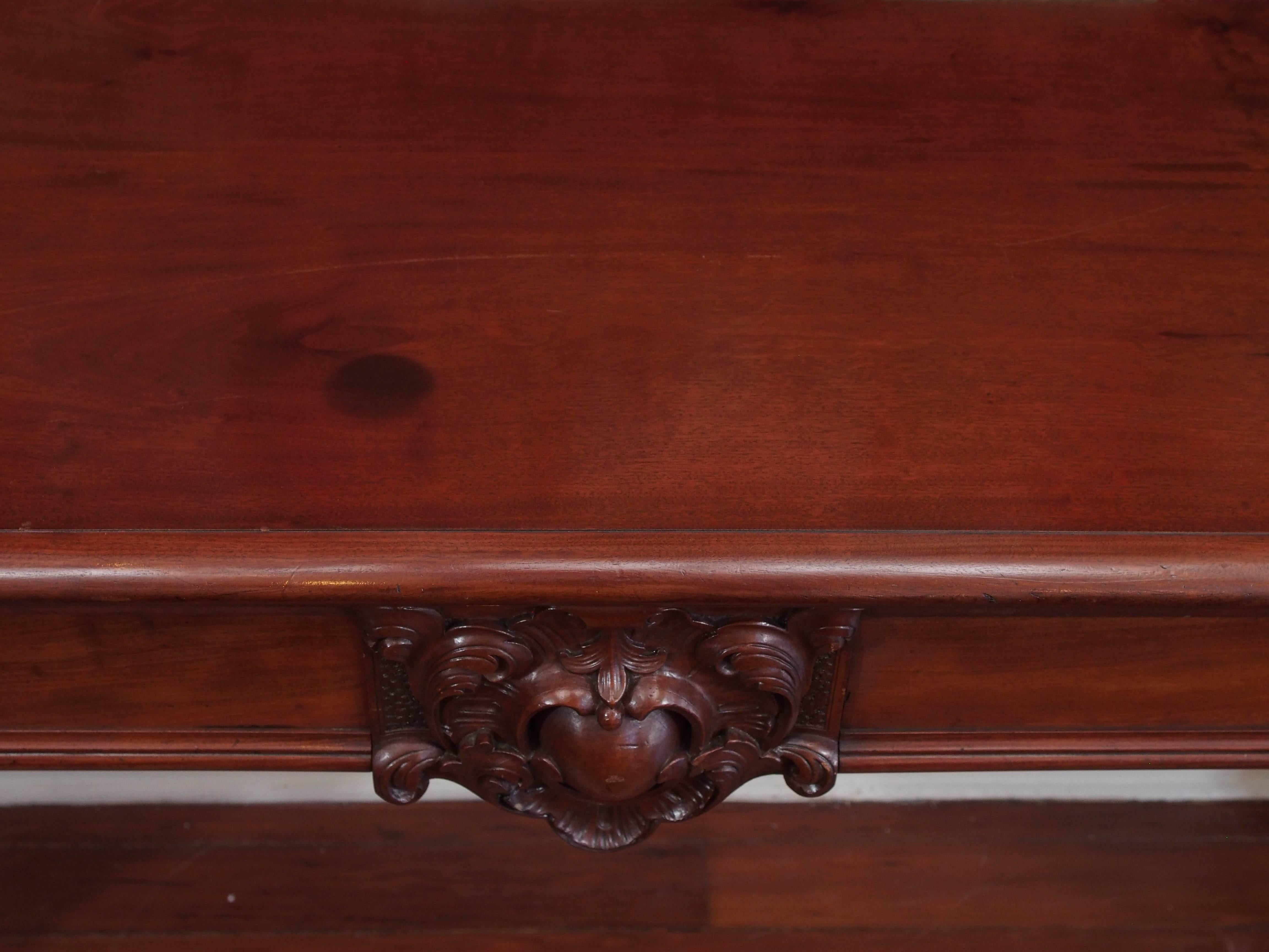 Large William IV mahogany carved serving table with drawers. Exceptionally carved legs and central cartouche.
