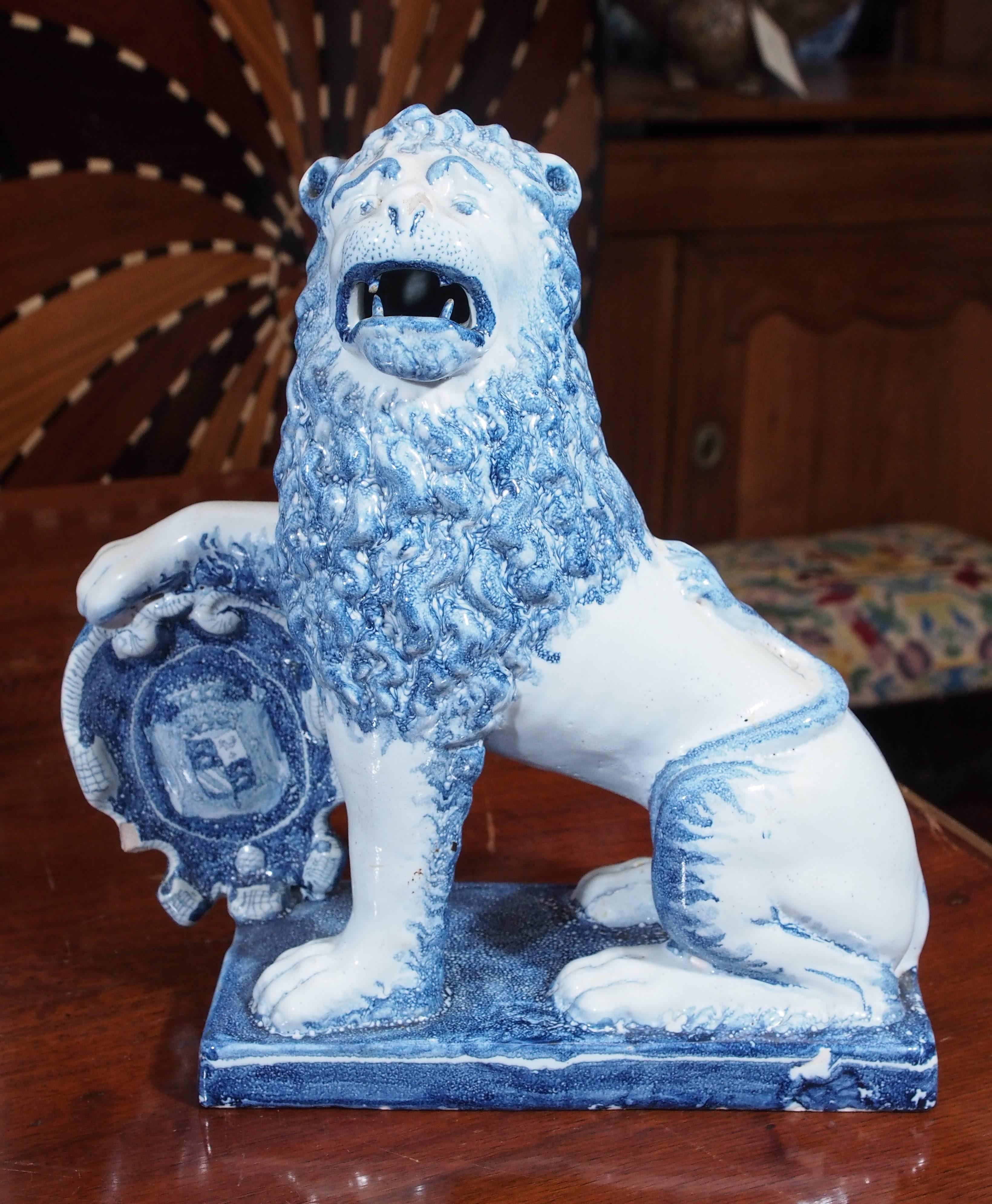 Pair of blue and white delft lions with shields.