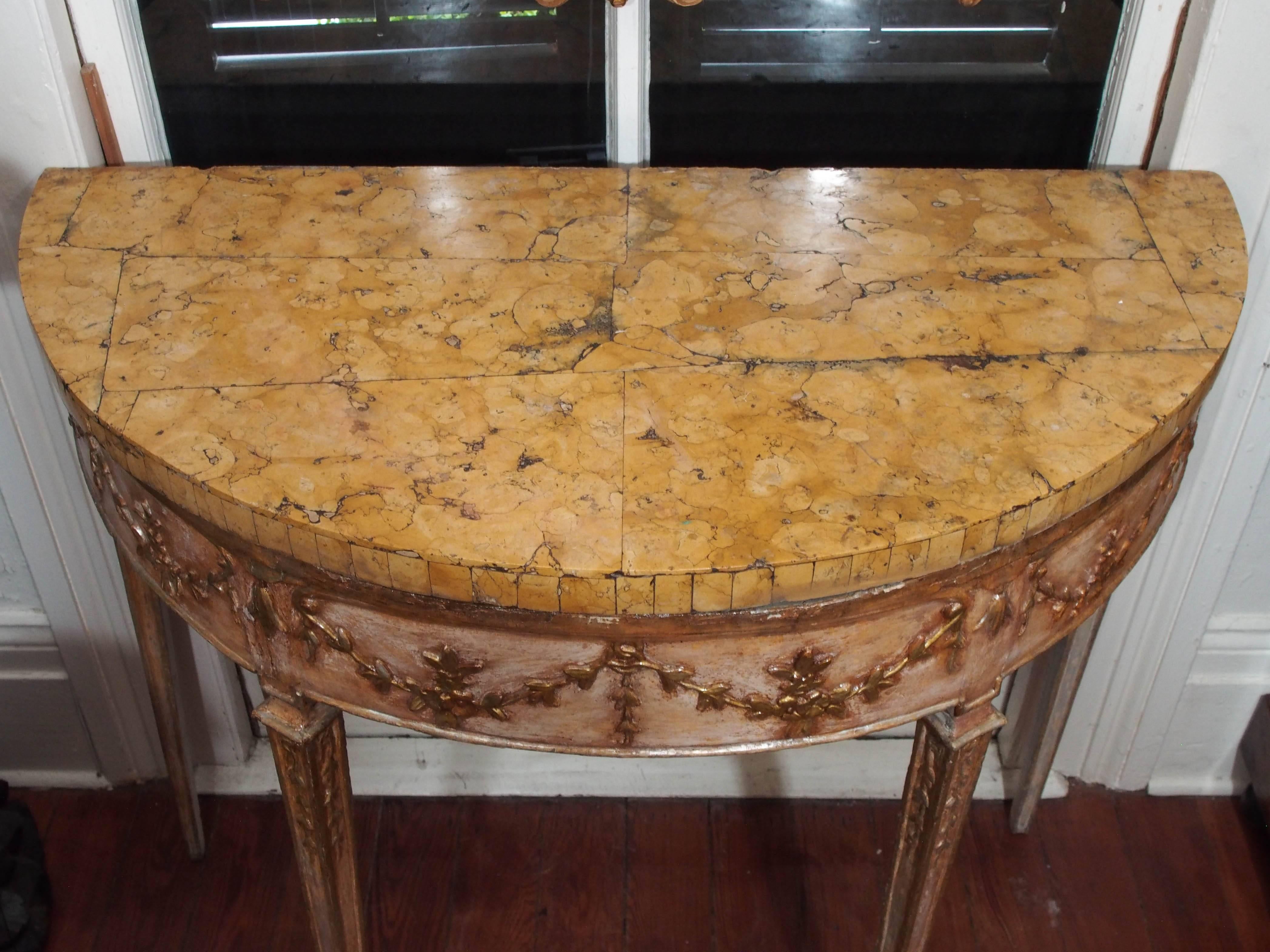 Pair of Italian painted and parcel-gilt Louis XVI demilune consoles with Sienna marble tops.